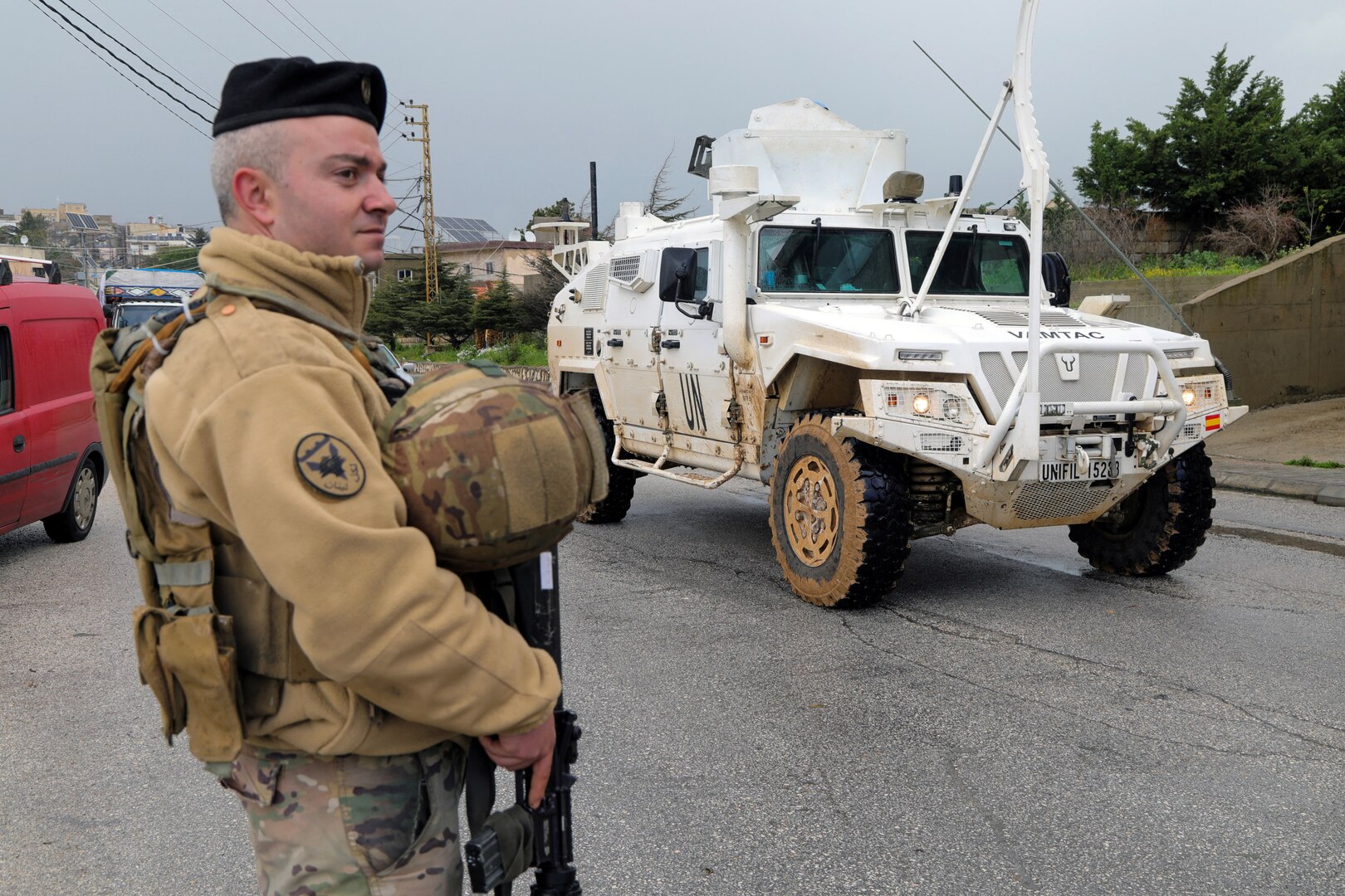 A UNIFIL vehicle drives past a Lebanese soldier, amid escalating hostilities between Israel and Hezbollah, as the US-Israel conflict with Iran continues, in Qlayaa, southern Lebanon, March 27, 2026. [Karamallah Daher/Reuters]