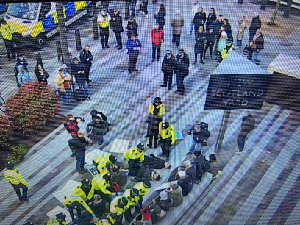Metropolitan Police officers arrest Palestine Action supporters outside New Scotland Yard in London on Saturday