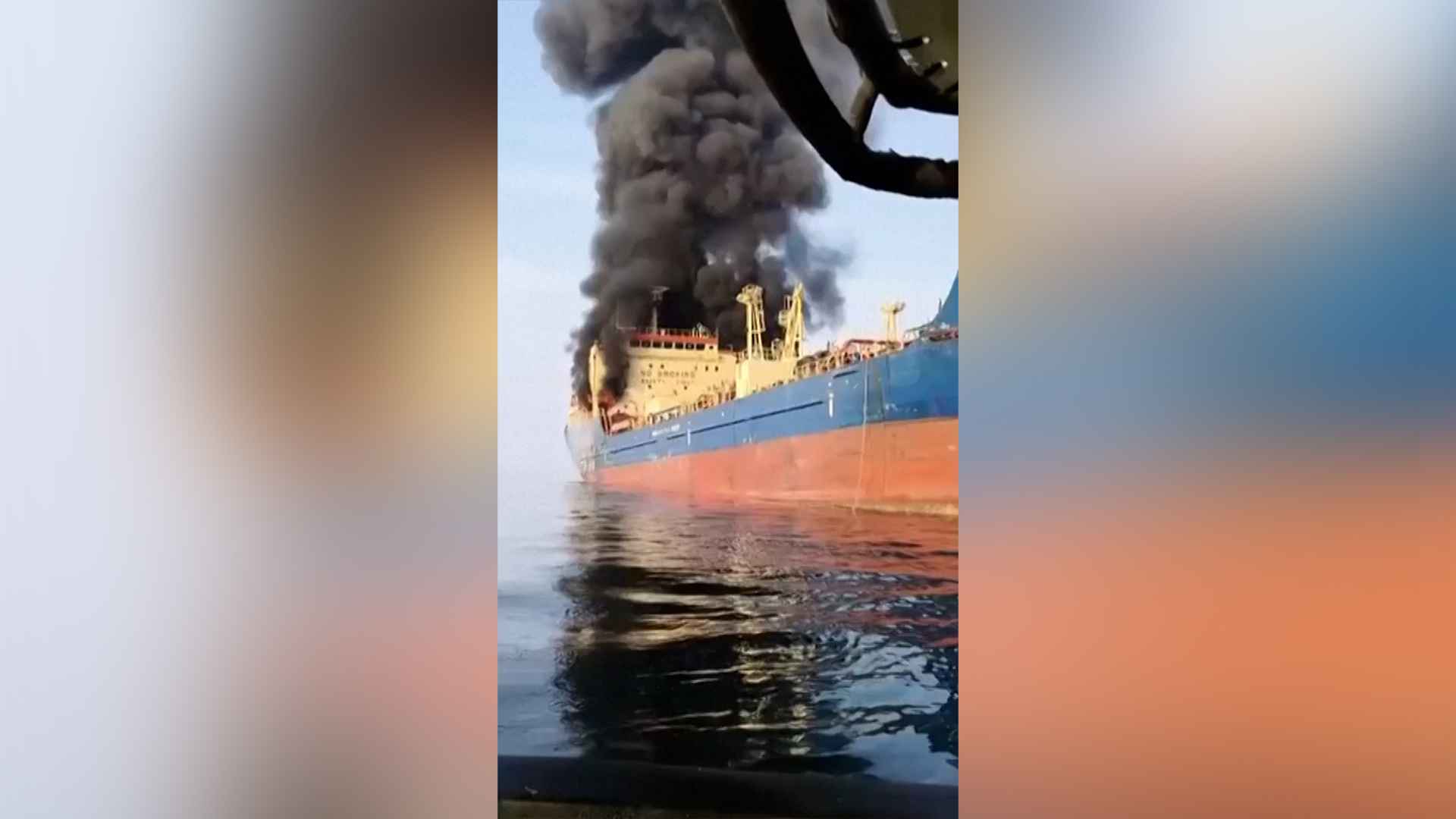 Smoke billows from an oil tanker under U.S. sanctions, that was hit off Oman's Musandam peninsula, in this screen grab from a video obtained by Reuters on March 1, 2026. [Reuters]