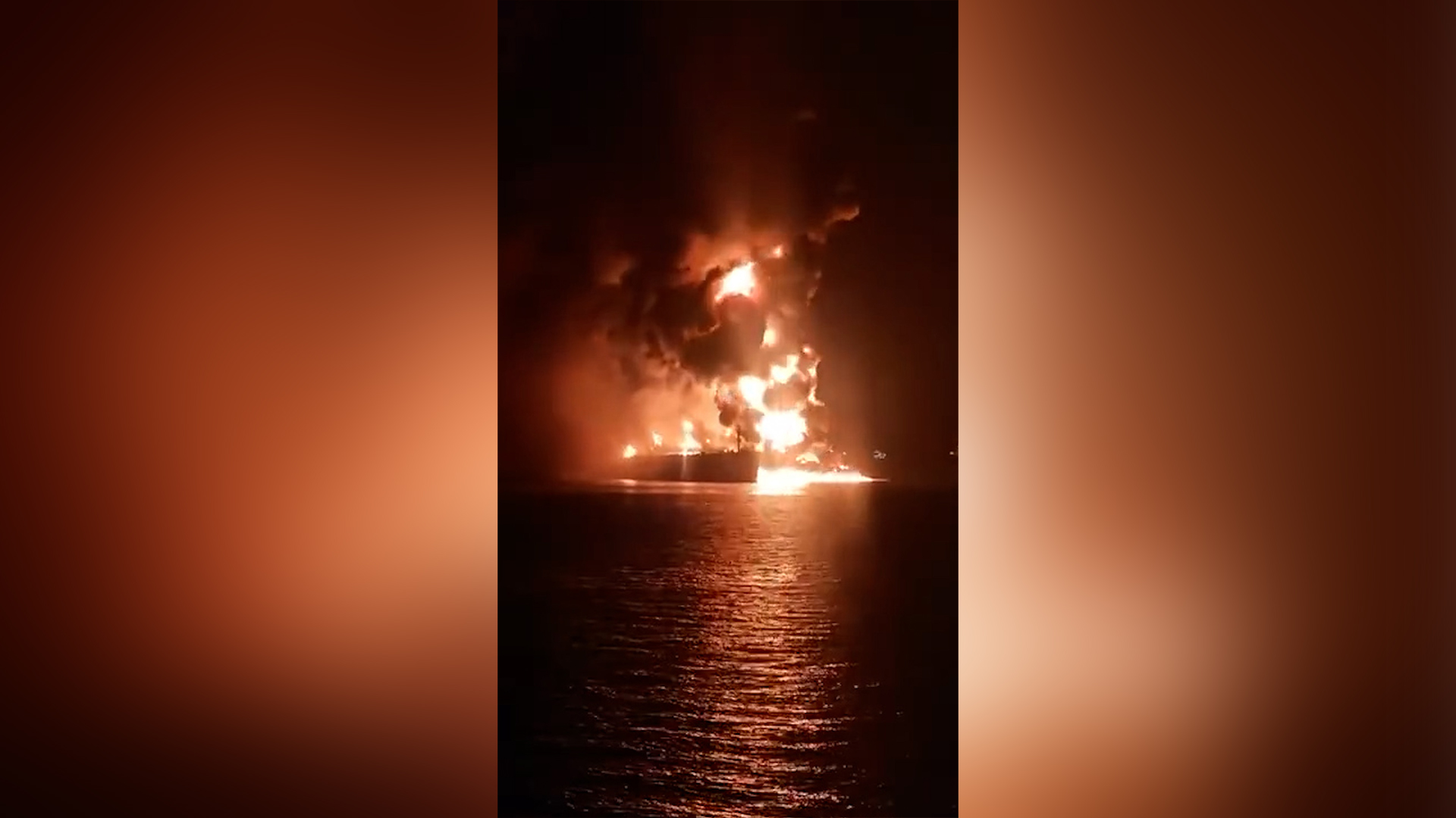 An oil tanker is seen on fire near Iraq's al-Faw port after being attacked. [Screenshot via social media]