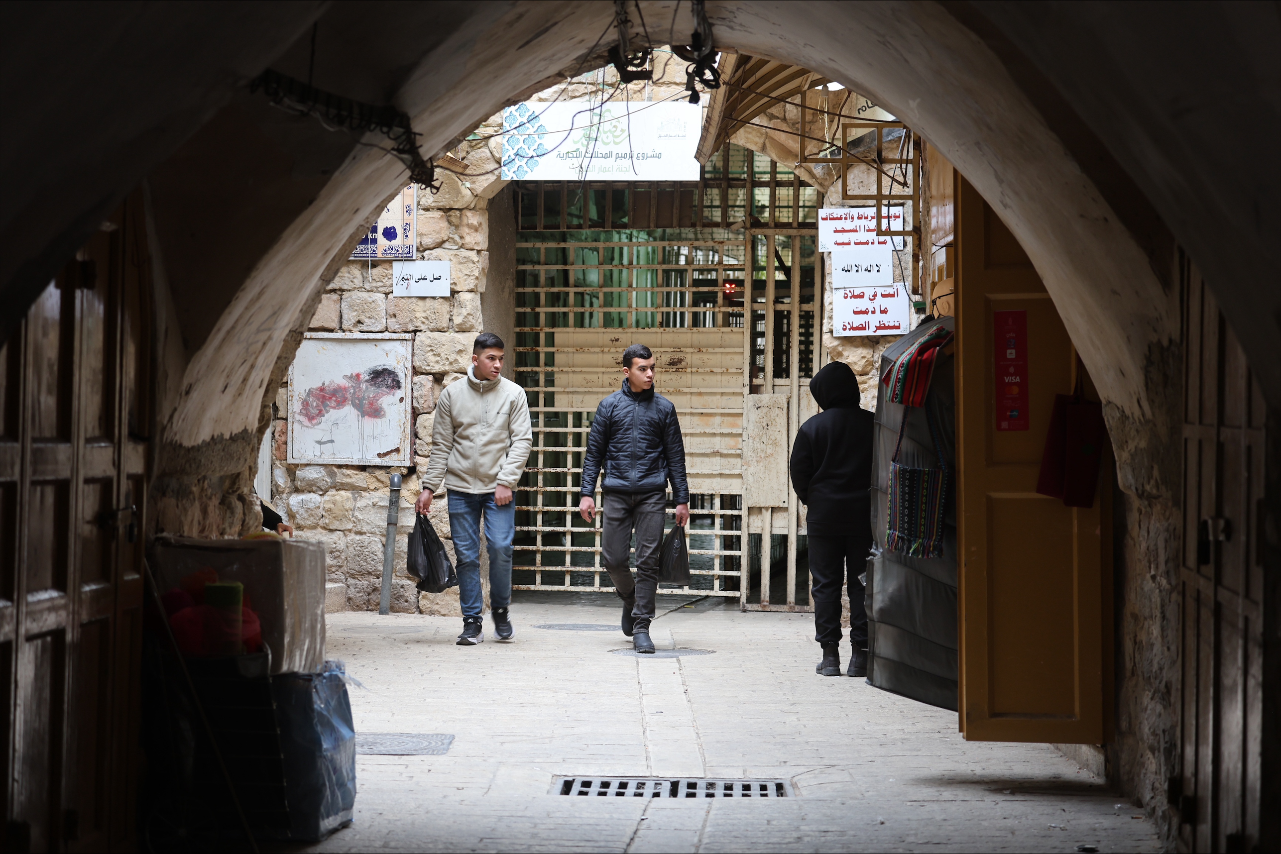 men walking under an arch