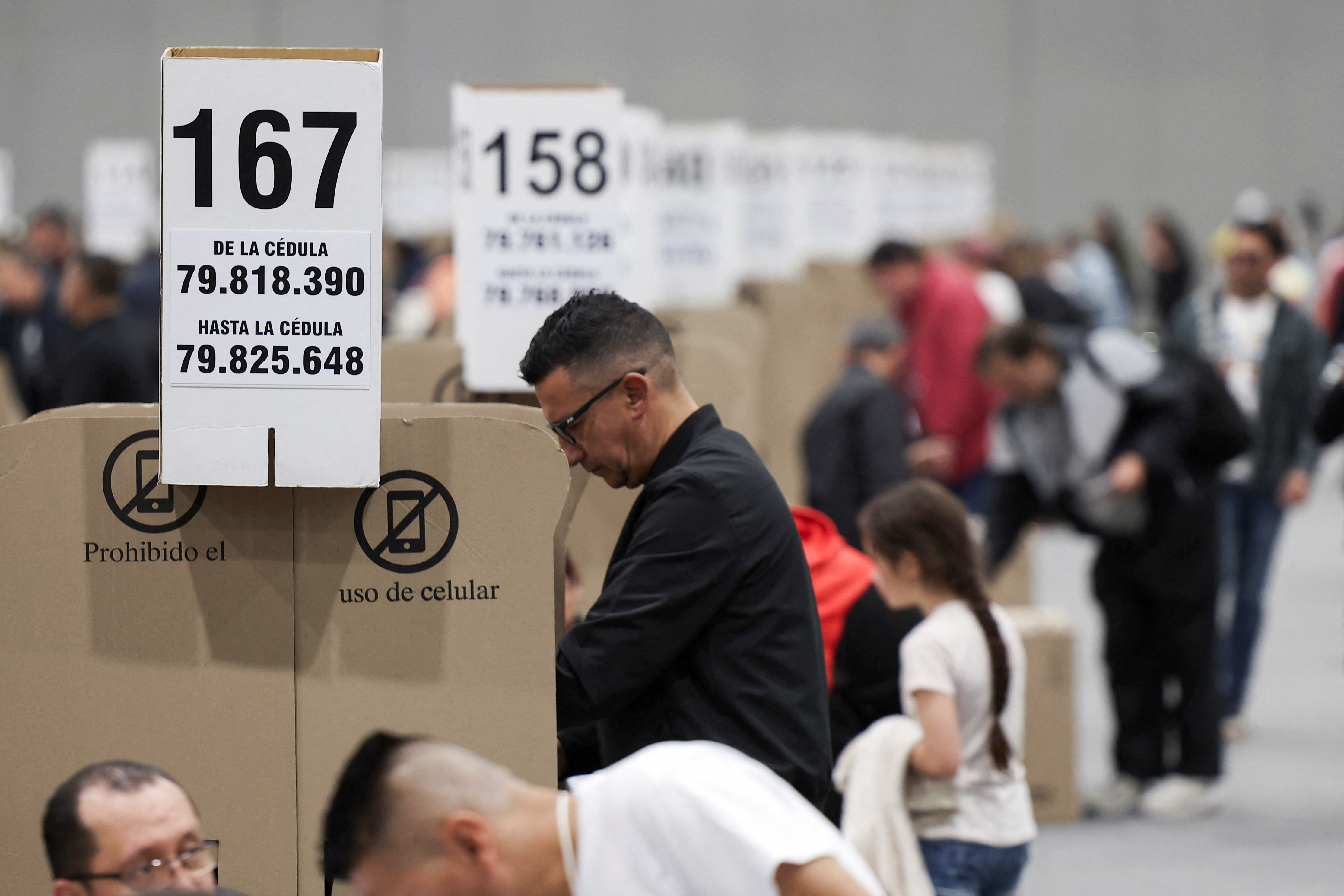 People vote at a polling station during the congressional elections and party primaries for presidential candidate, in Bogota, Colombia March 8, 2026. REUTERS/Luisa Gonzalez