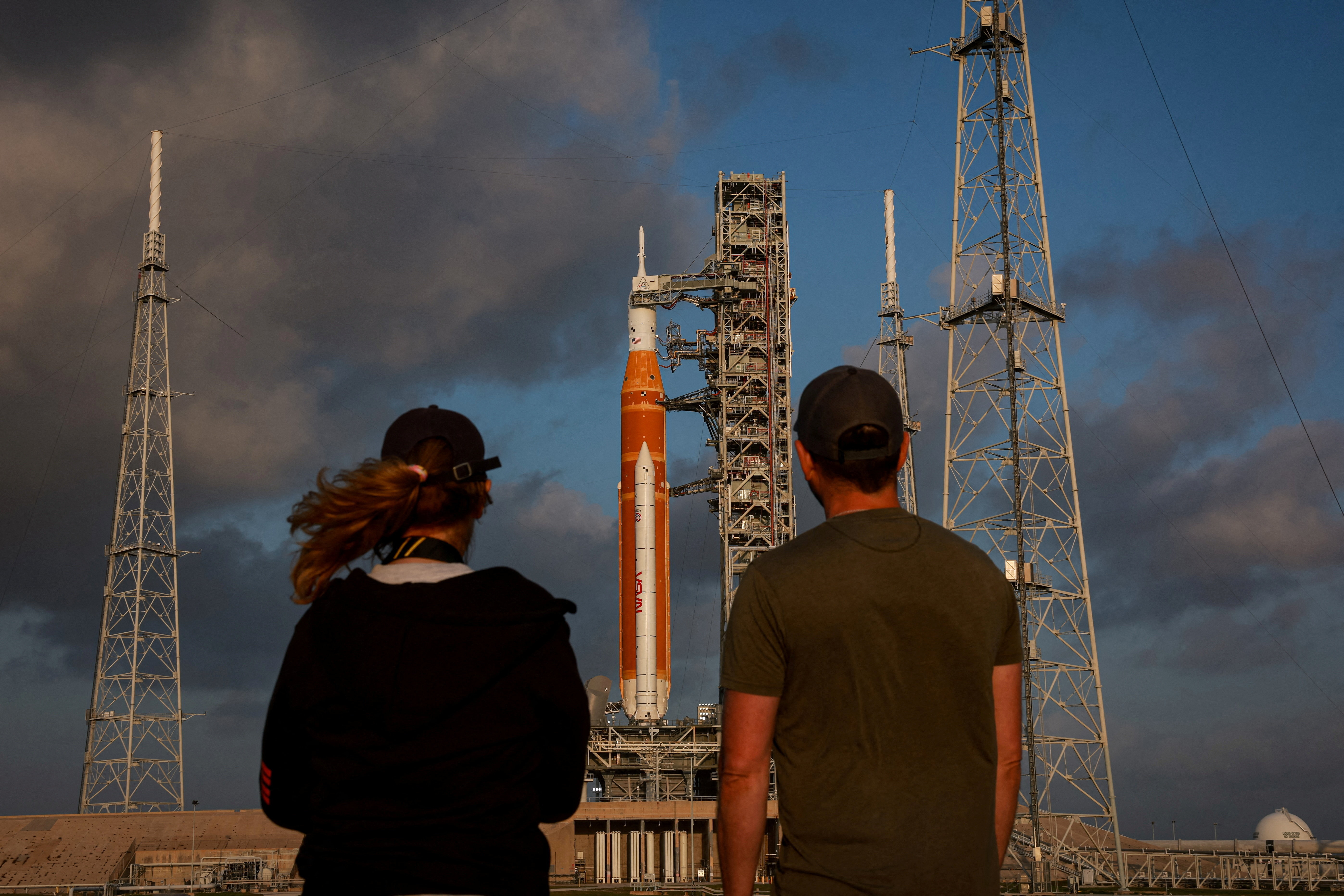 People look at NASA's next-generation moon rocket, the Space Launch System (SLS) rocket with the Orion crew capsule, on Pad 39B ahead of the Artemis II mission launch at the Kennedy Space Center in Cape Canaveral, Florida, U.S., March 29, 2026. REUTERS/Brendan McDermid TPX IMAGES OF THE DAY