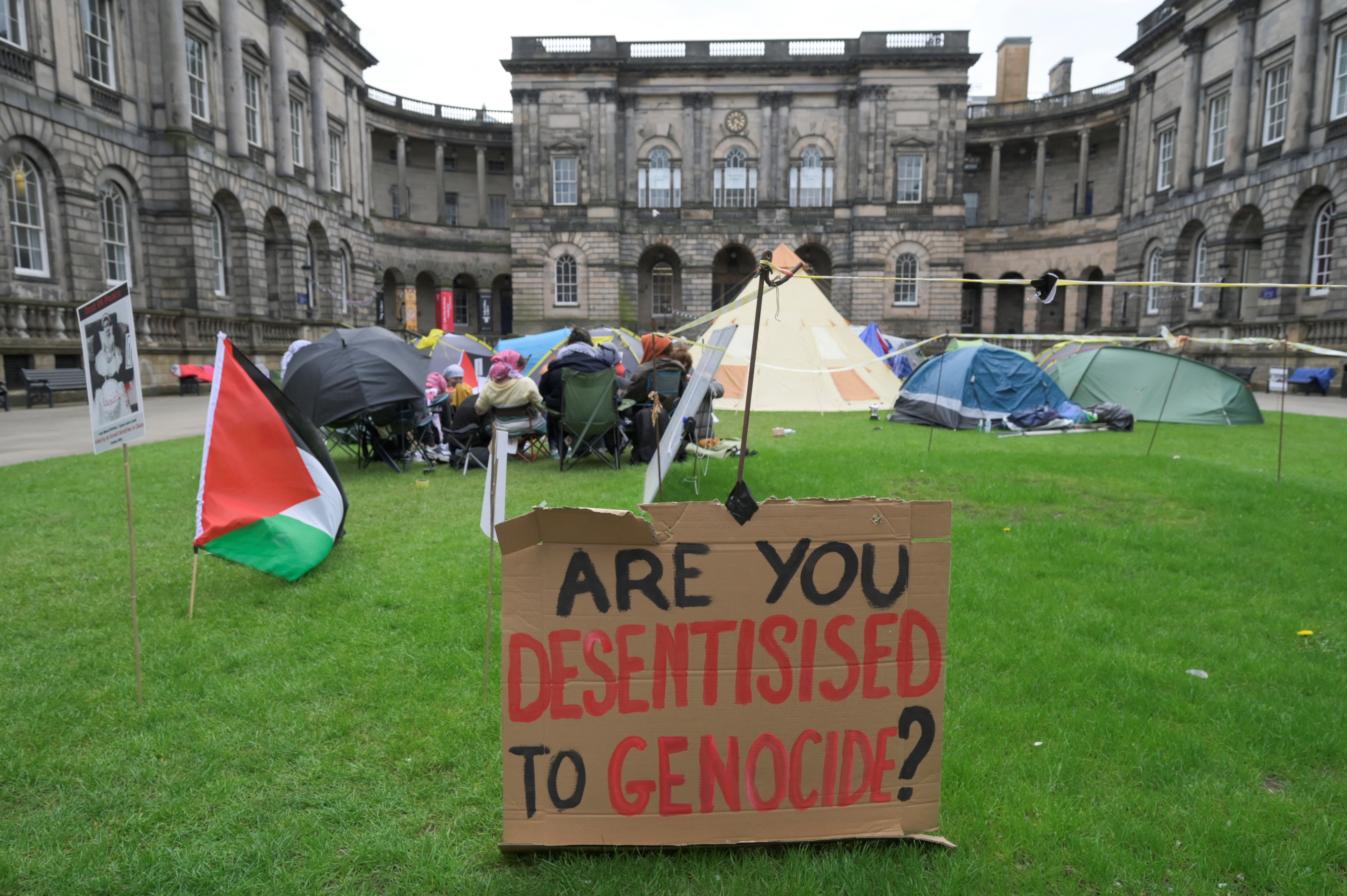 A placard is set at a student encampment.