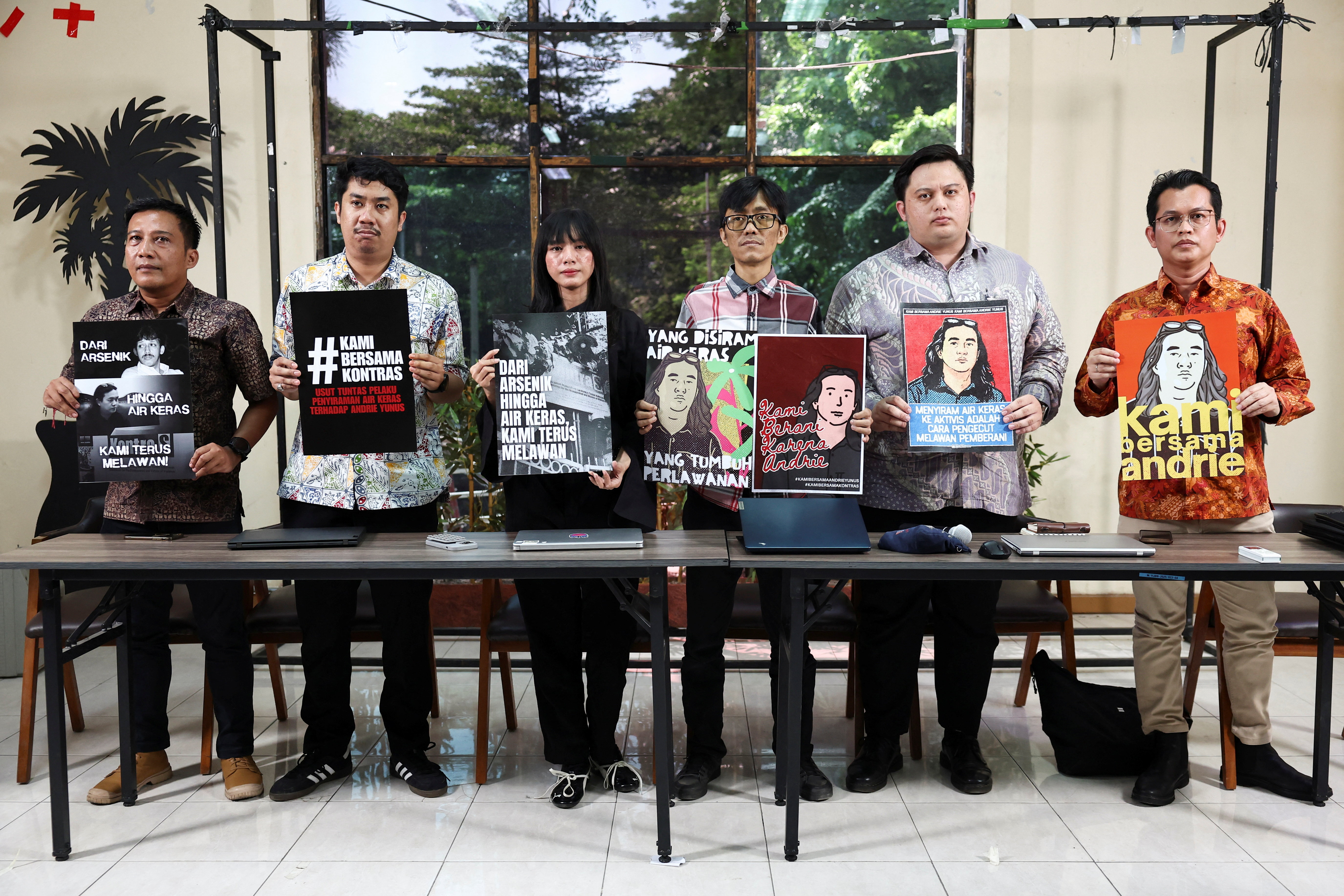 Advocacy for Democracy Team (TAUD) members hold posters in solidarity with Andrie Yunus, an activist and deputy coordinator with Indonesia's rights group Commission for Missing Persons and Victims of Violence (KontraS), who suffered burns to 24% of his face and arms from acid thrown by two unidentified assailants on a motorcycle on March 12, after a press conference in Jakarta, Indonesia, March 16, 2026. REUTERS/Willy Kurniawan