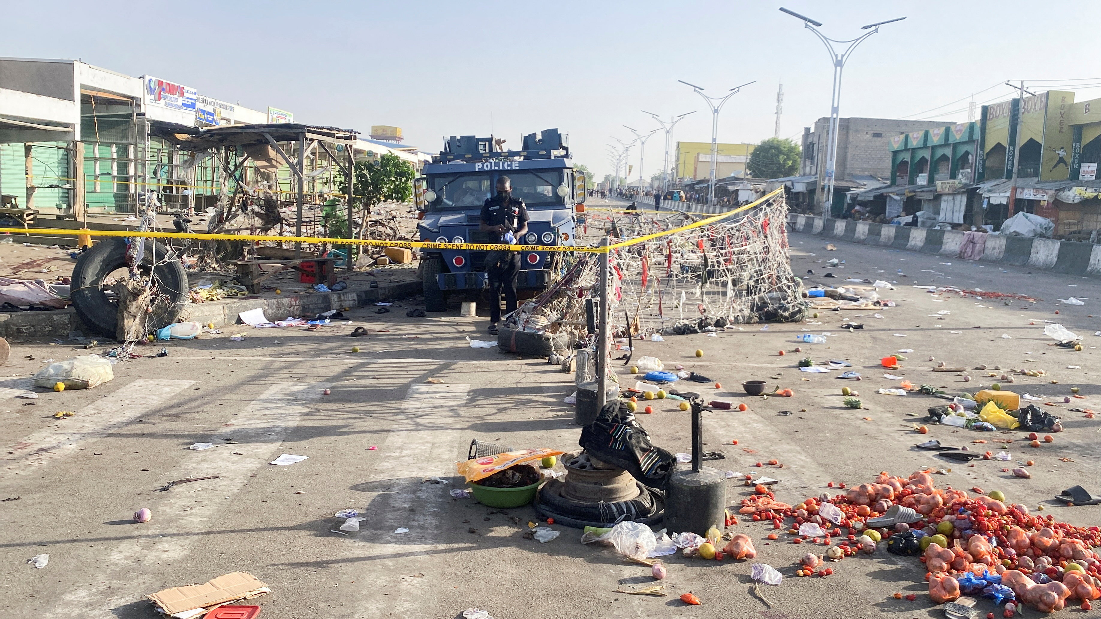 A Nigerian police truck stands at a deserted market.