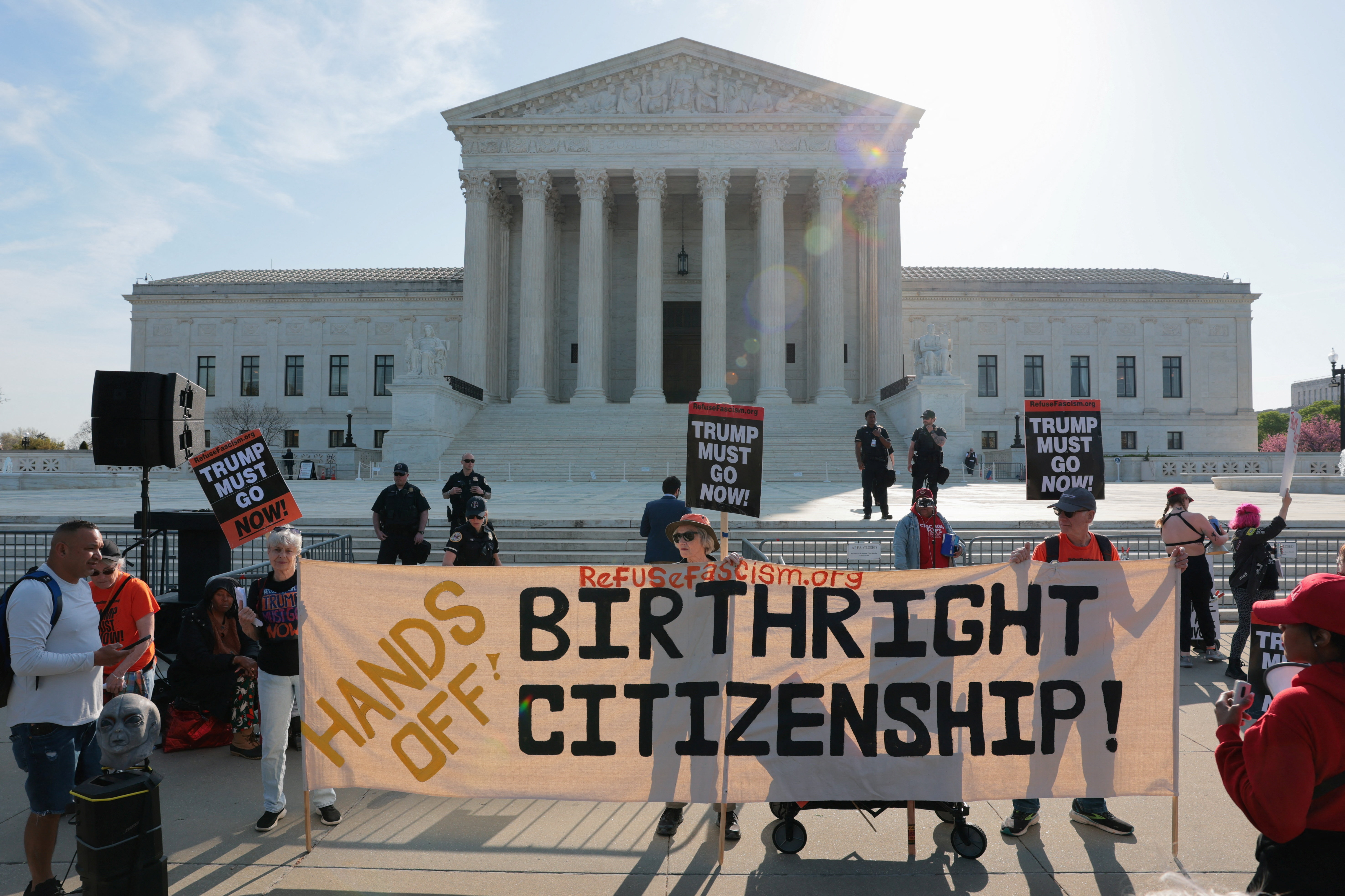 Demonstrators hold signs outside the U.S. Supreme Court building on the day the court is expected to hear oral arguments on the legality of the Trump administration's effort to limit birthright citizenship for the children of immigrants, in Washington, D.C., U.S., April 1, 2026. REUTERS/Kylie Cooper