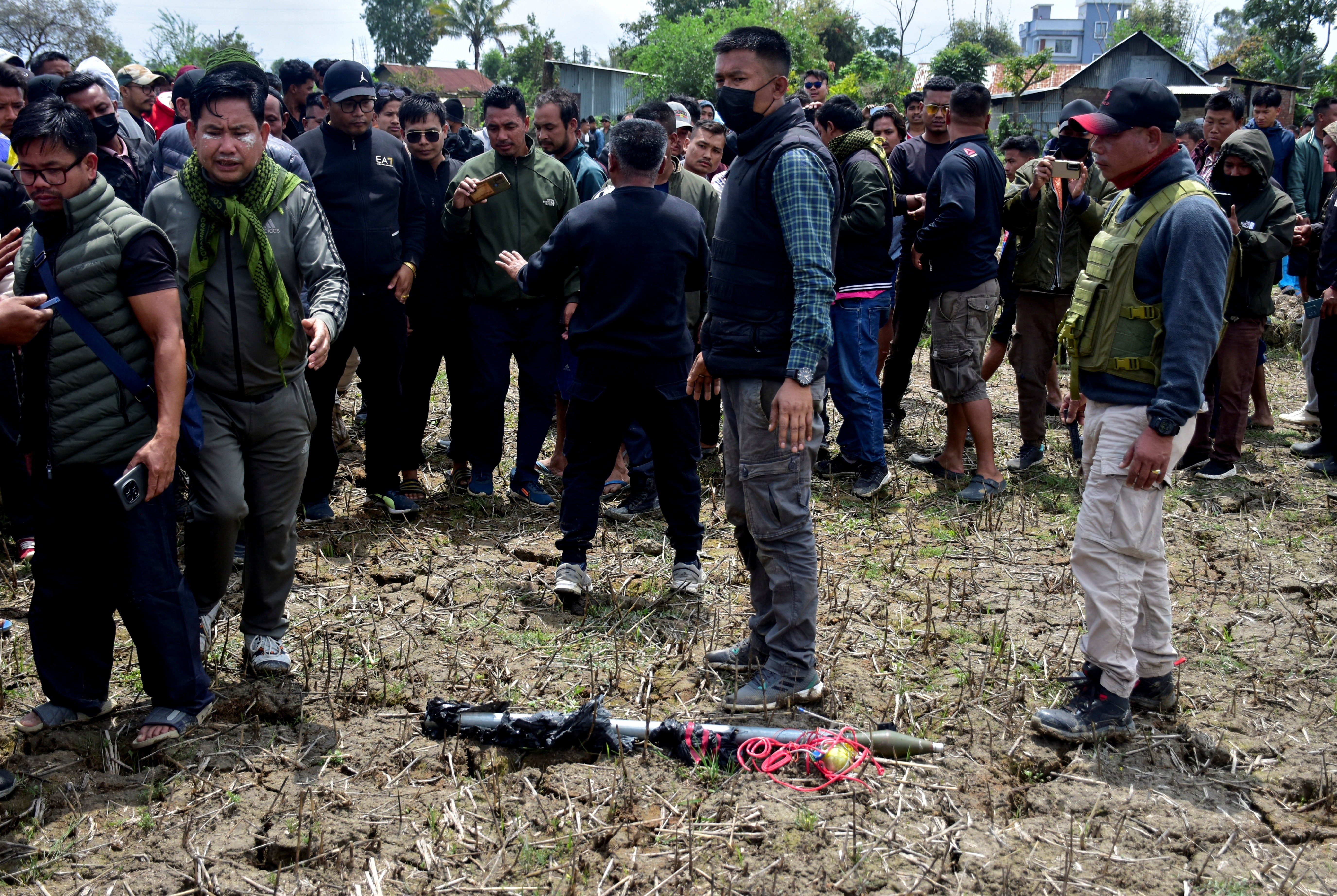 People gather around a weapon on the ground, which was defused by a bomb disposal squad, in Bishnupur district, Manipur, India, April 7, 2026 [Reuters]