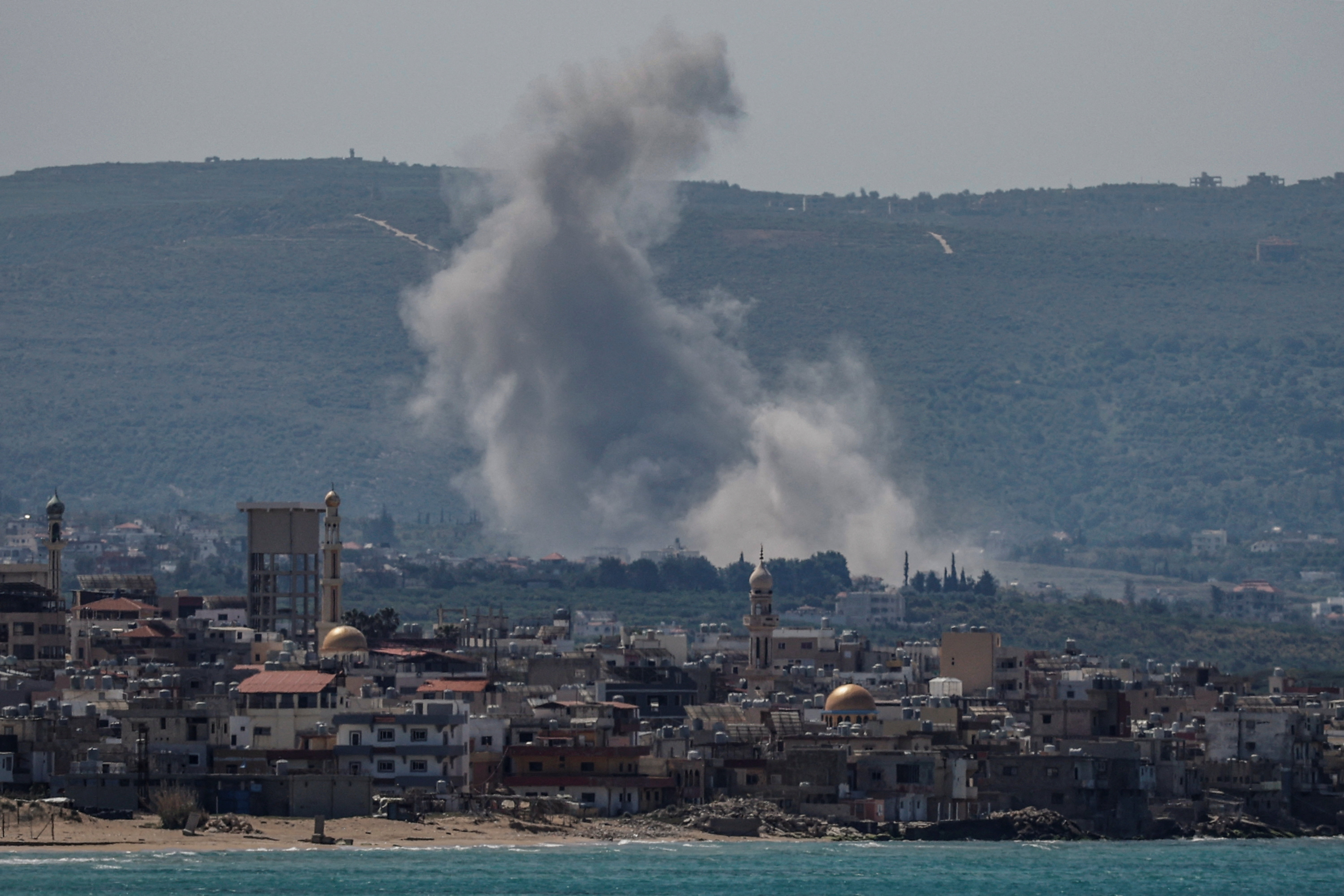 Smoke rises following an Israeli strike at Qlaile