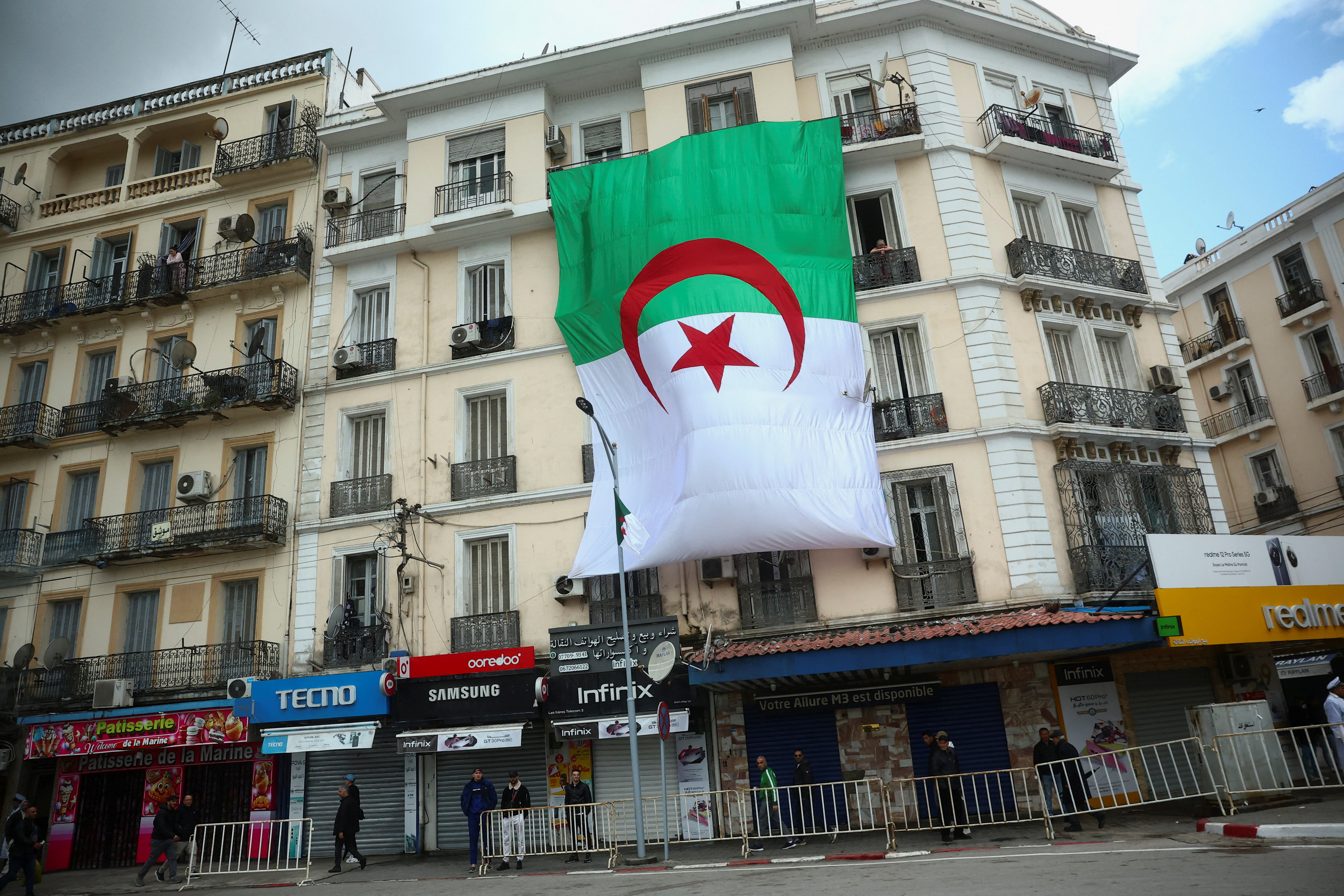 The national flag of Algeria hangs outside a building on the day of Pope Leo XIV's visit to Annaba, Algeria, April 14, 2026. REUTERS/Guglielmo Mangiapane