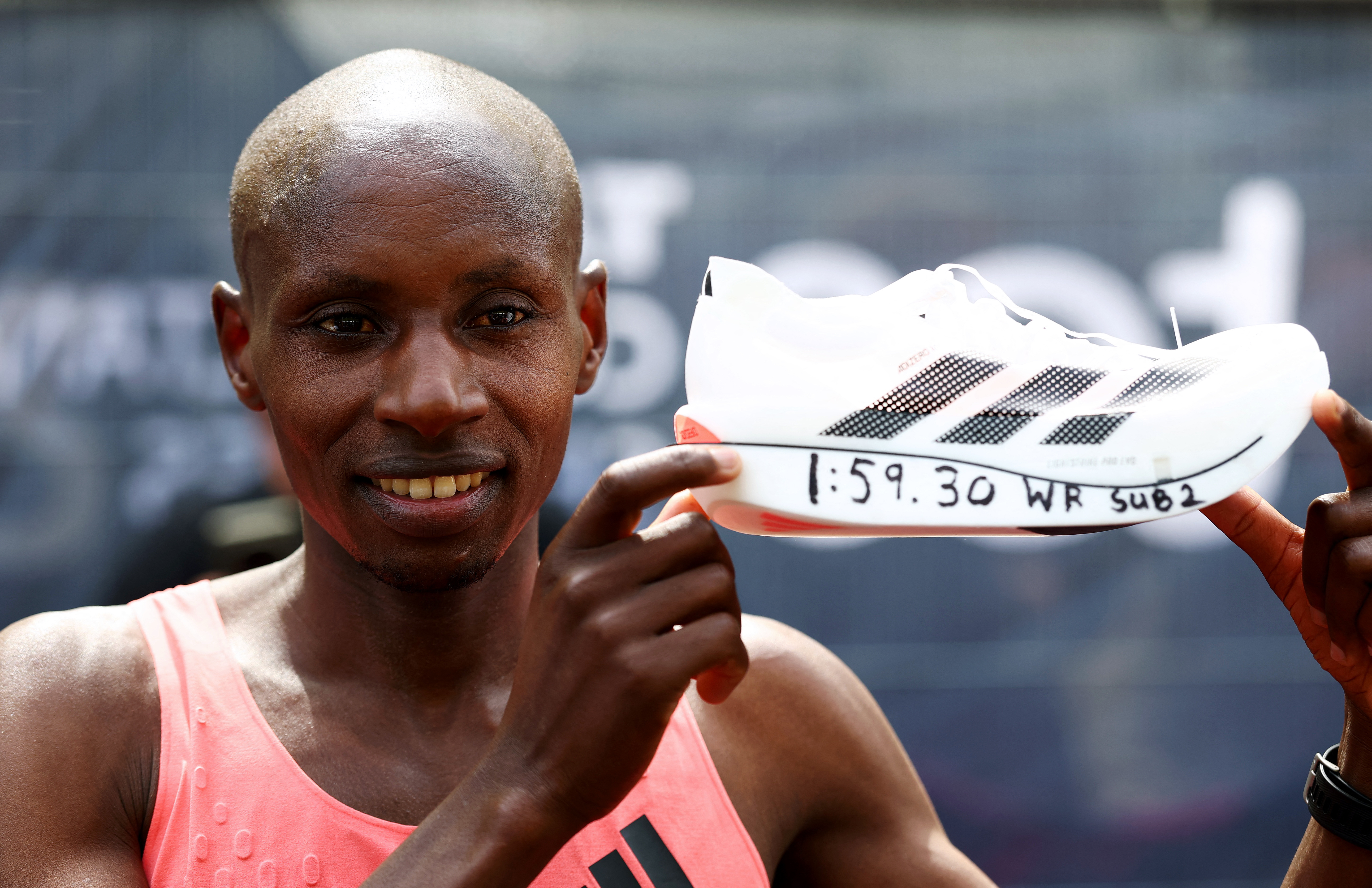 Athletics - London Marathon - London, Britain - April 26, 2026 Kenya's Sabastian Sawe celebrates with a shoe after winning the men's elite race and setting a new world record with a time of 01:59:30 REUTERS/Matthew Childs