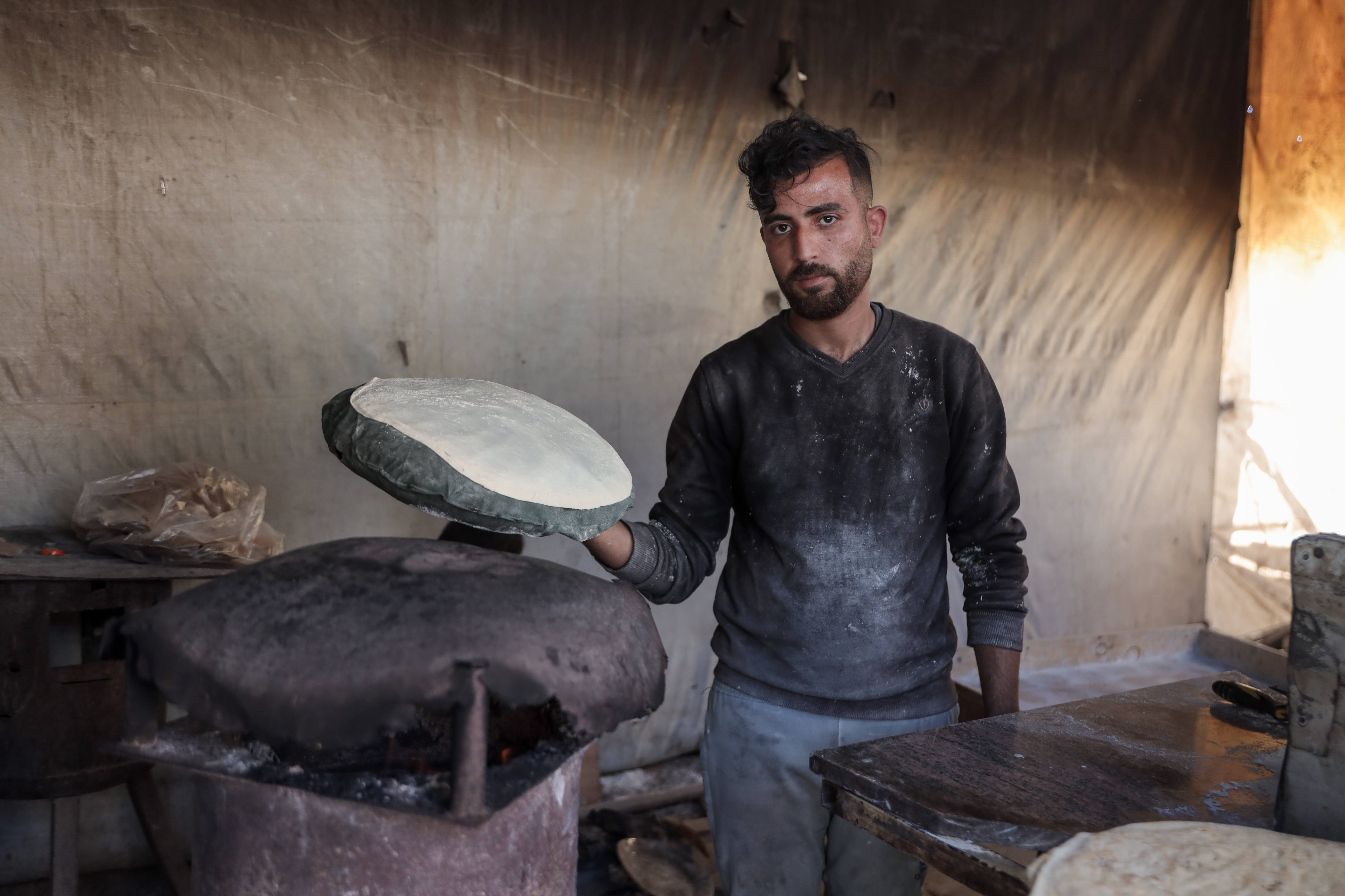 Yousef Al-Rifi during his work in one of the temporary bakeries in central Gaza City, as a job opportunity to help support his family and his two children