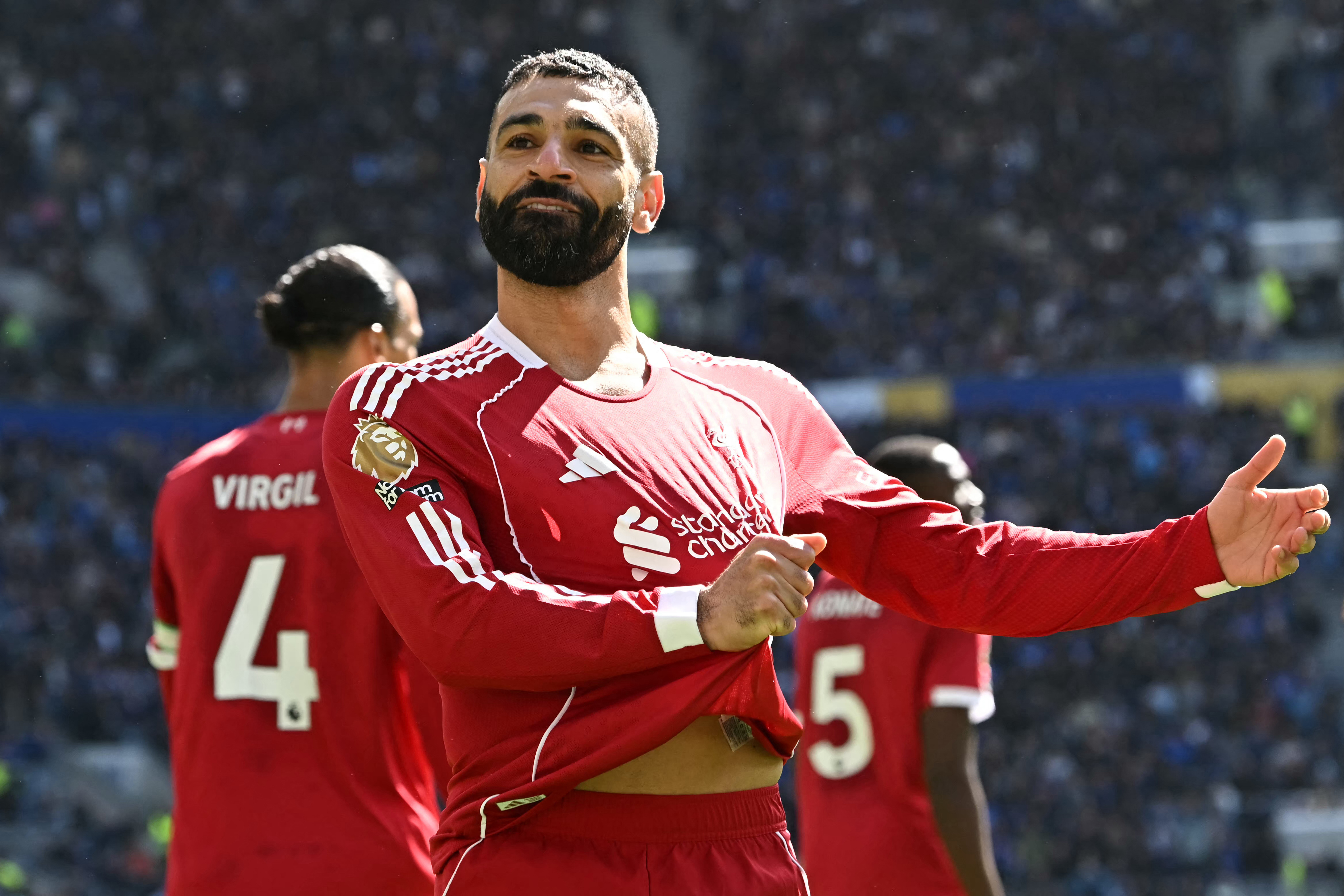 Liverpool's Egyptian striker #11 Mohamed Salah celebrates after scoring the opening goal of the English Premier League football match between Everton and Liverpool at Hill Dickinson Stadium in Liverpool, north west England on April 19, 2026. (Photo by Paul ELLIS / AFP) / RESTRICTED TO EDITORIAL USE. No use with unauthorized audio, video, data, fixture lists, club/league logos or 'live' services. Online in-match use limited to 120 images. An additional 40 images may be used in extra time. No video emulation. Social media in-match use limited to 120 images. An additional 40 images may be used in extra time. No use in betting publications, games or single club/league/player publications. /