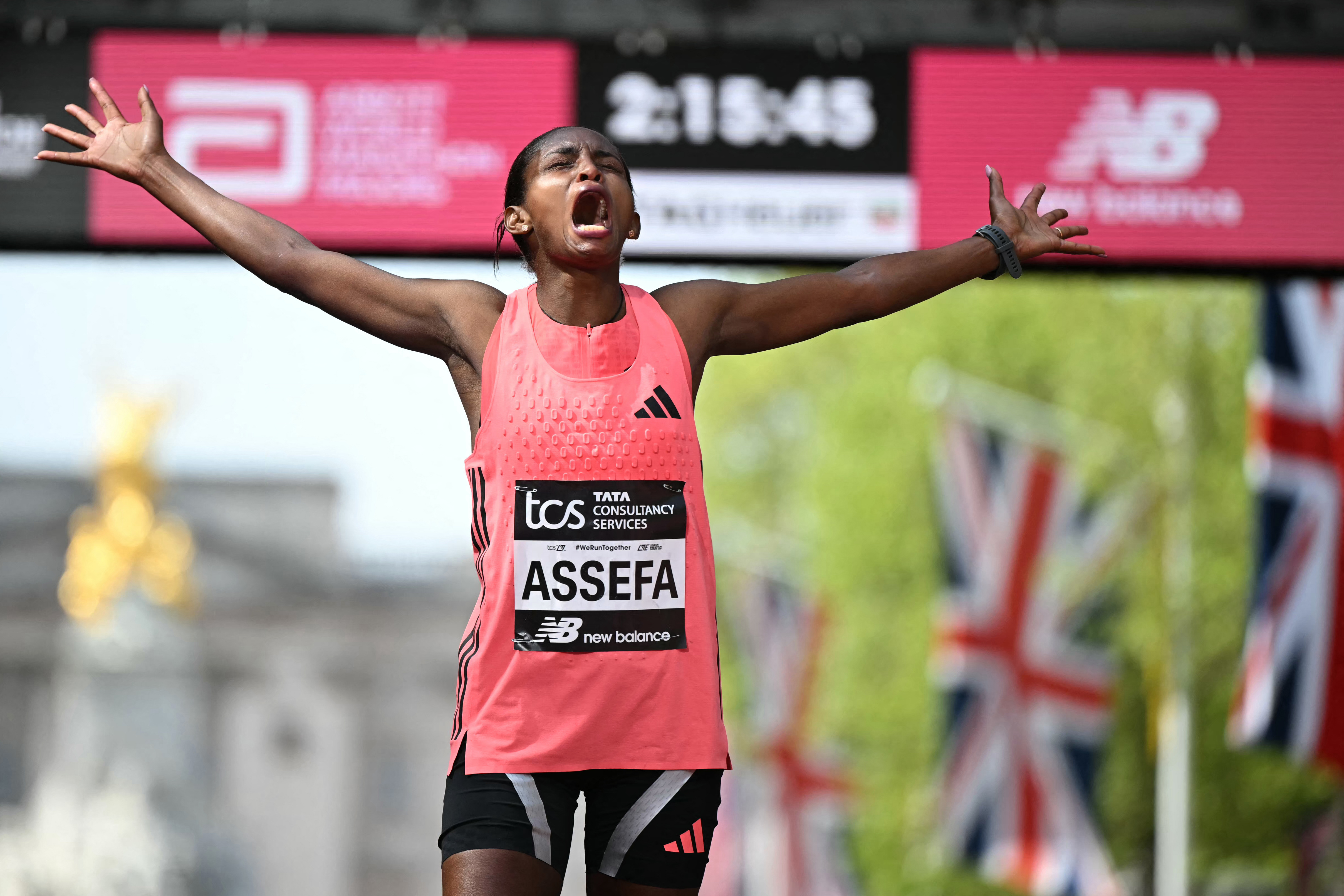 Ethiopia's Tigst Assefa reacts after crossing the line to win the women's race in a new women's only world record at the 2026 London Marathon in central London on April 26, 2026. (Photo by JUSTIN TALLIS / AFP) / Restricted to editorial use - sponsorship of content subject to LMEL agreement.