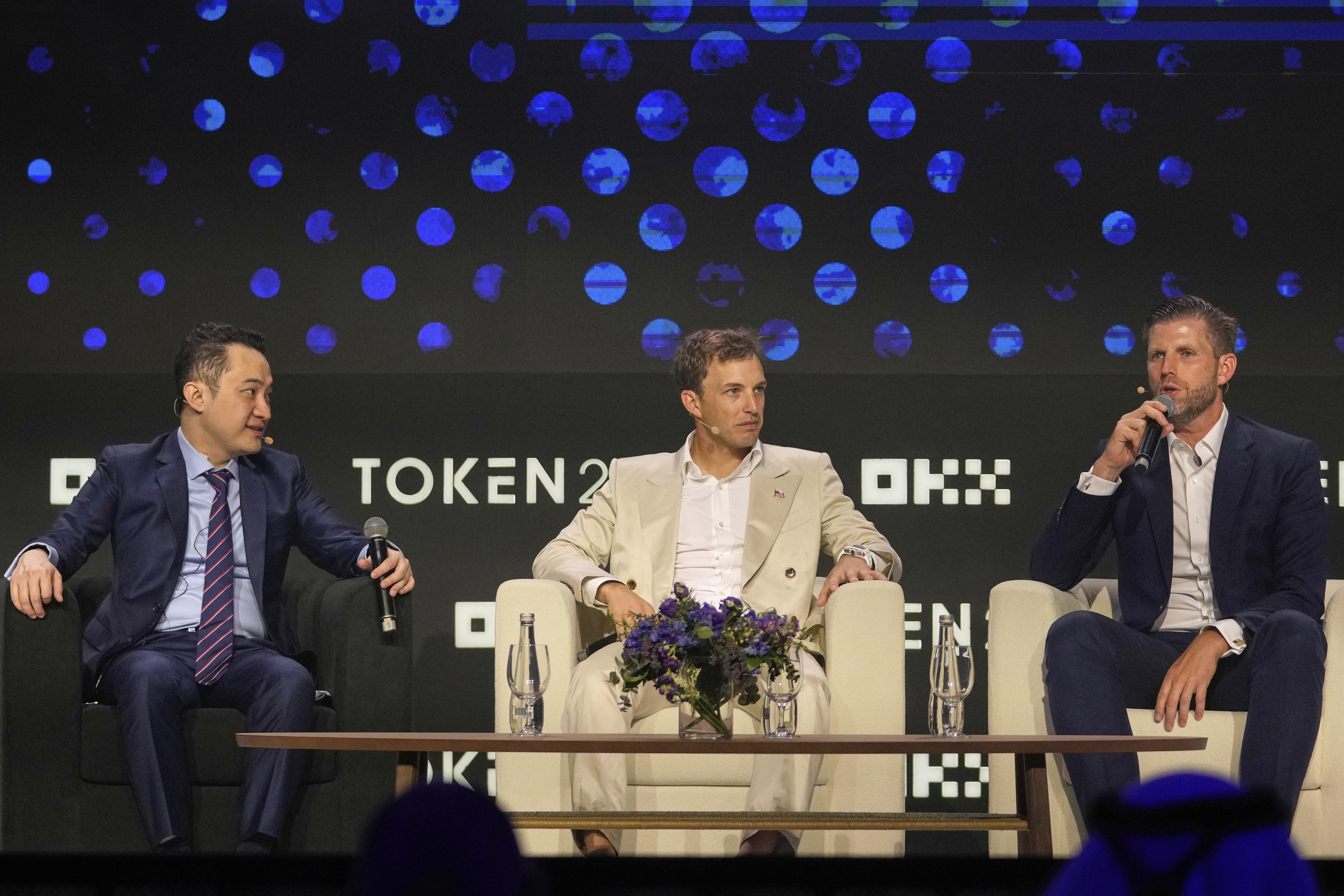Eric Trump, Executive VP of The Trump Organization, from right, speaks as Co-founder of World Liberty Financial Zach Witkoff and Founder of TRON Justin Sun look on during Token 2049, a Crypto event, in Dubai, United Arab Emirates