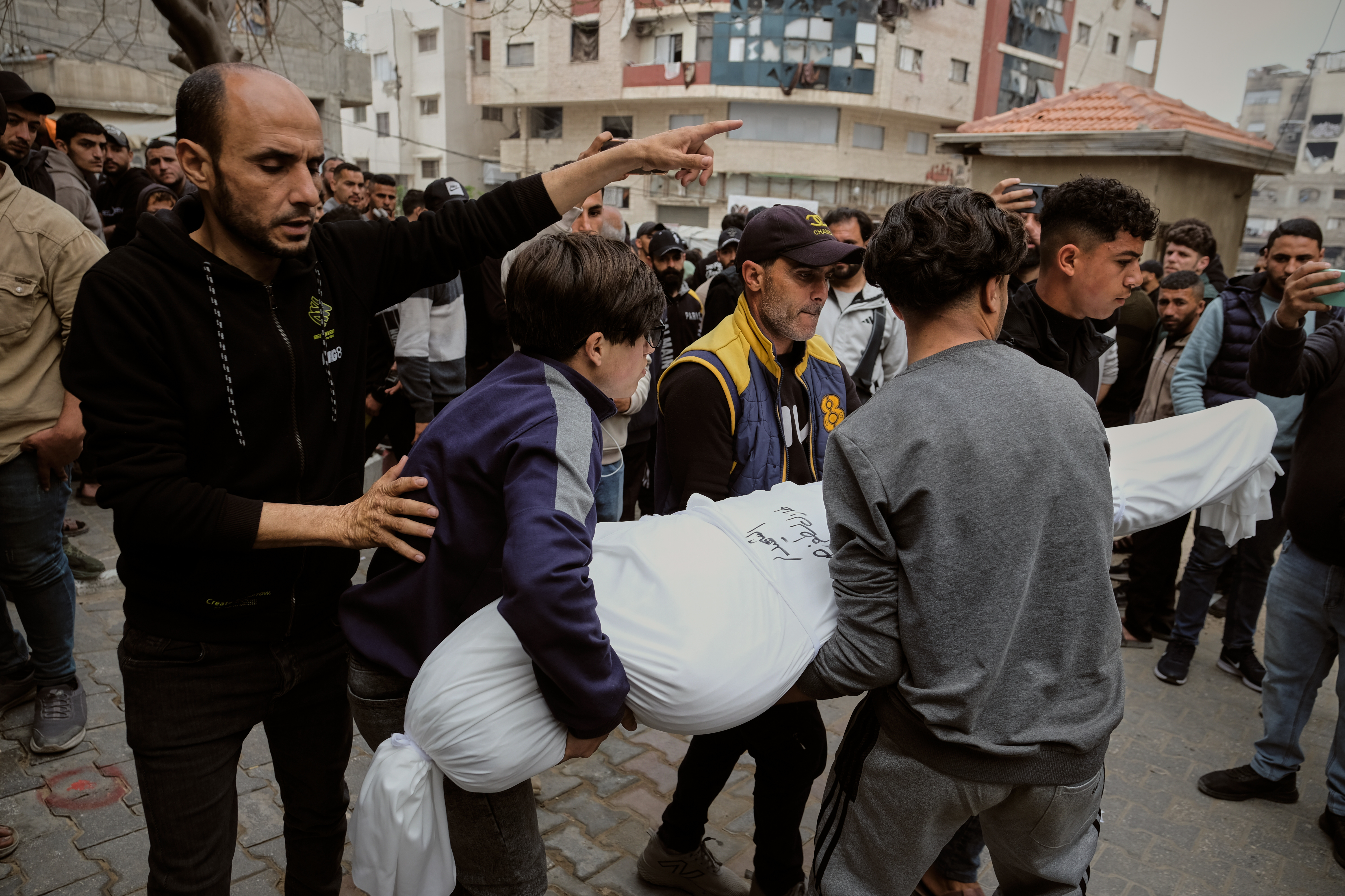 Mourners carry the bodies of Palestinians