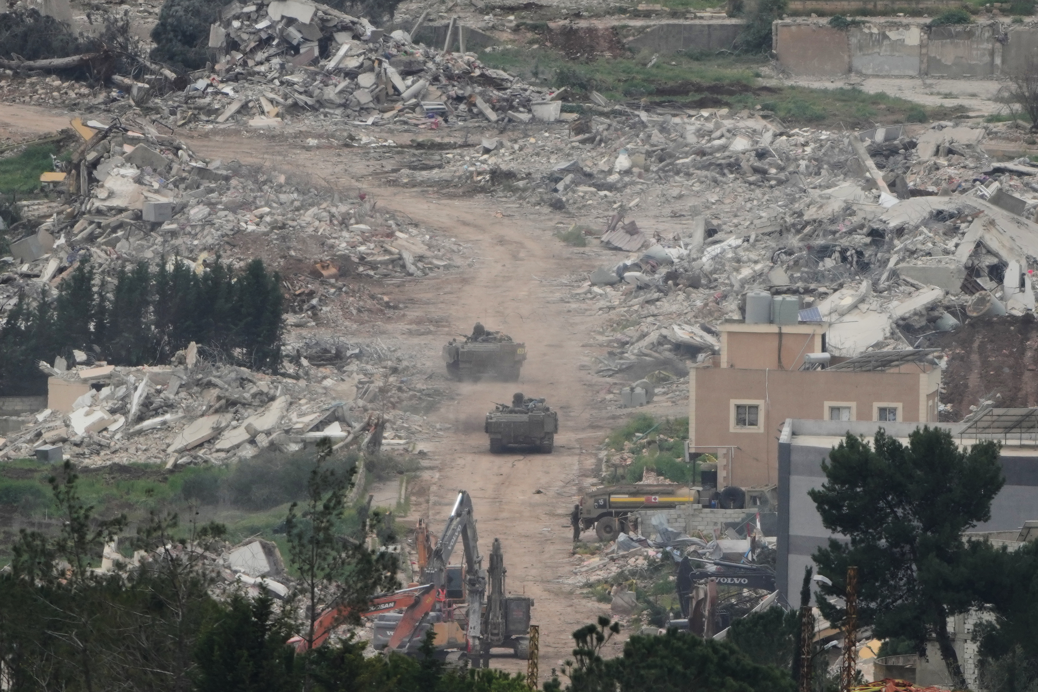Israeli army vehicles and bulldozers operate in southern Lebanon, as seen from northern Israel, Wednesday, April 15, 2026. (AP Photo/Ariel Schalit)