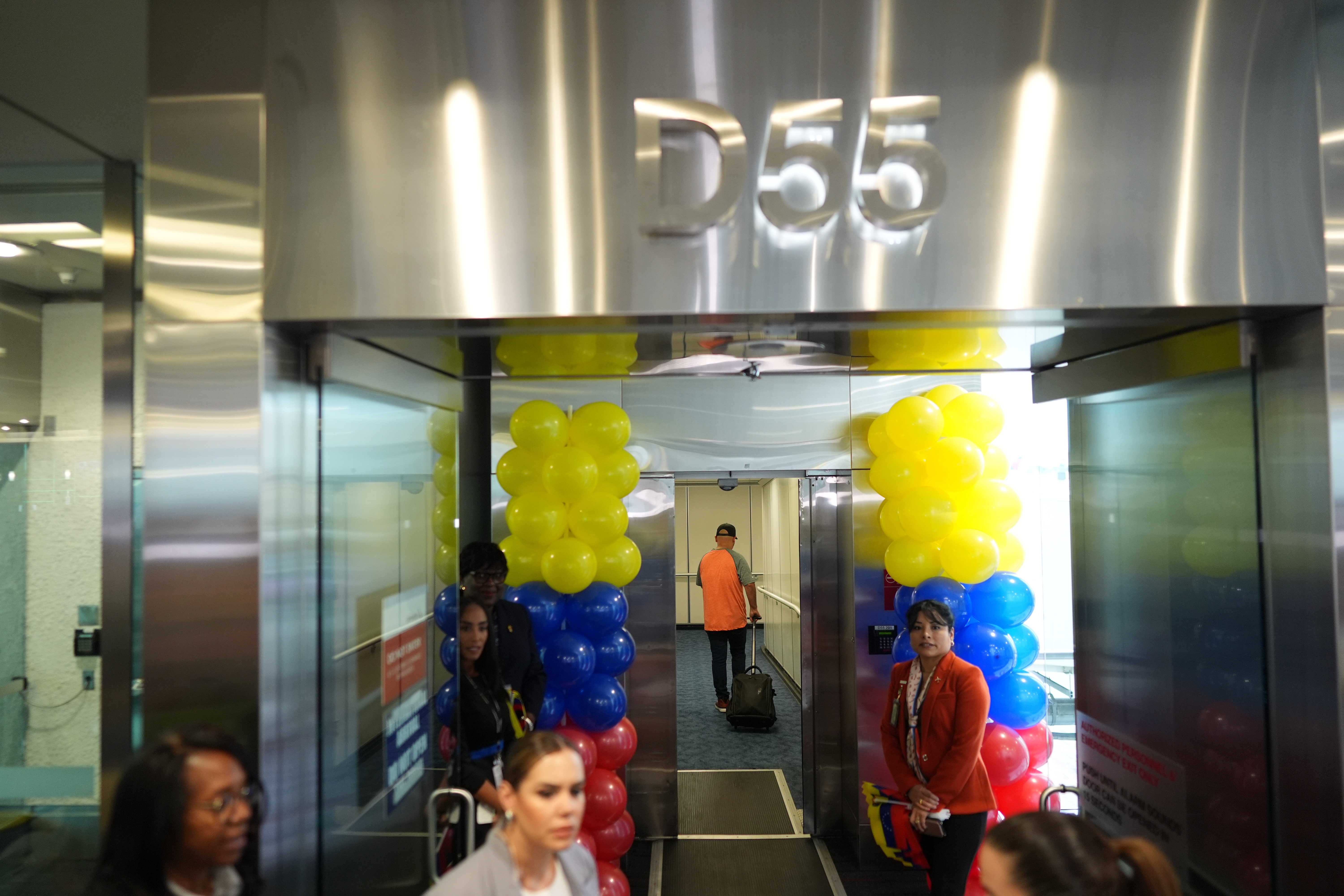 A passengers walks down the jet bridge to board American Airlines Flight AA3599, the first direct commercial flight 