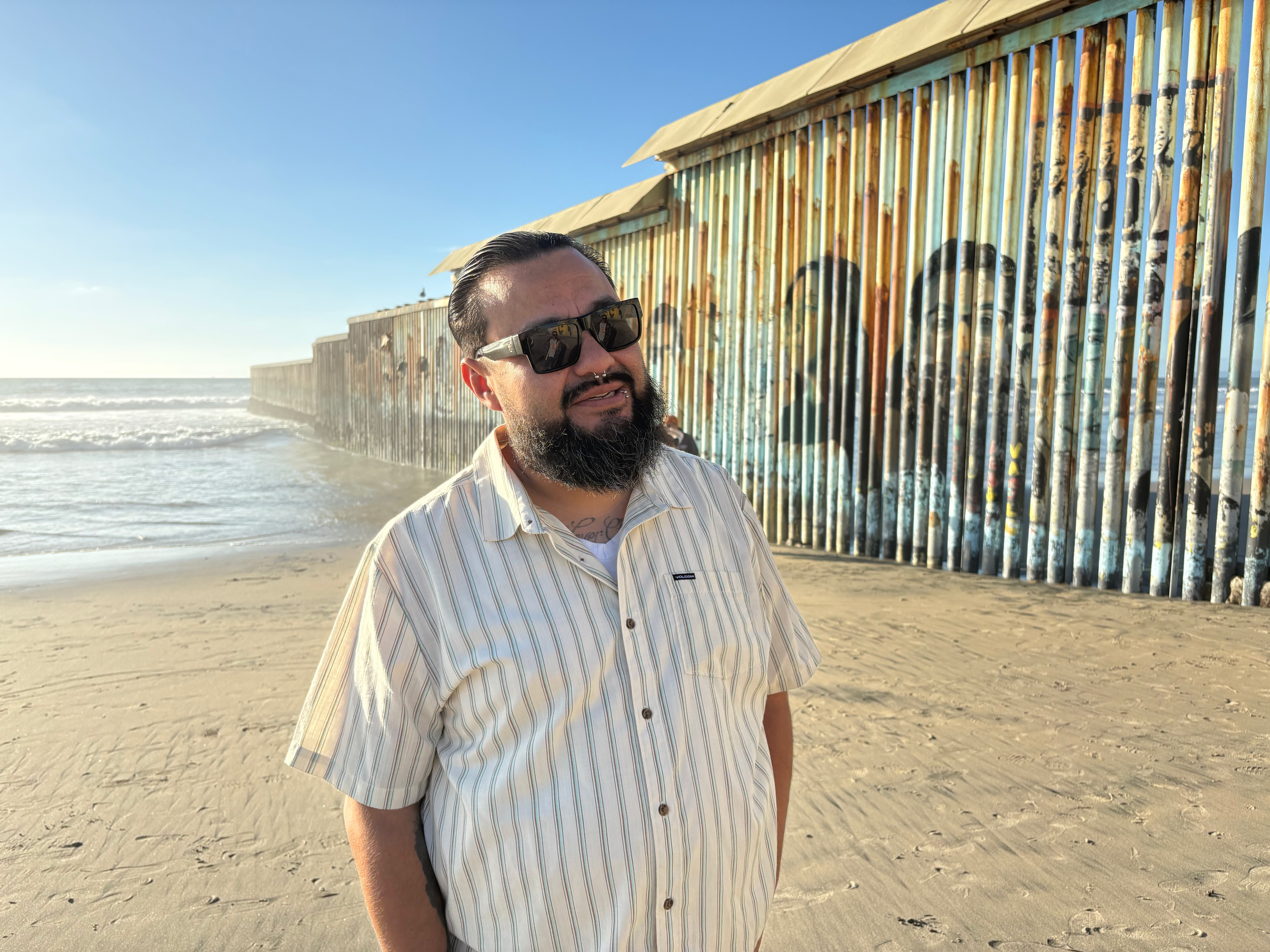 Edwin Salgado on the Pacific beach where the border wall ends