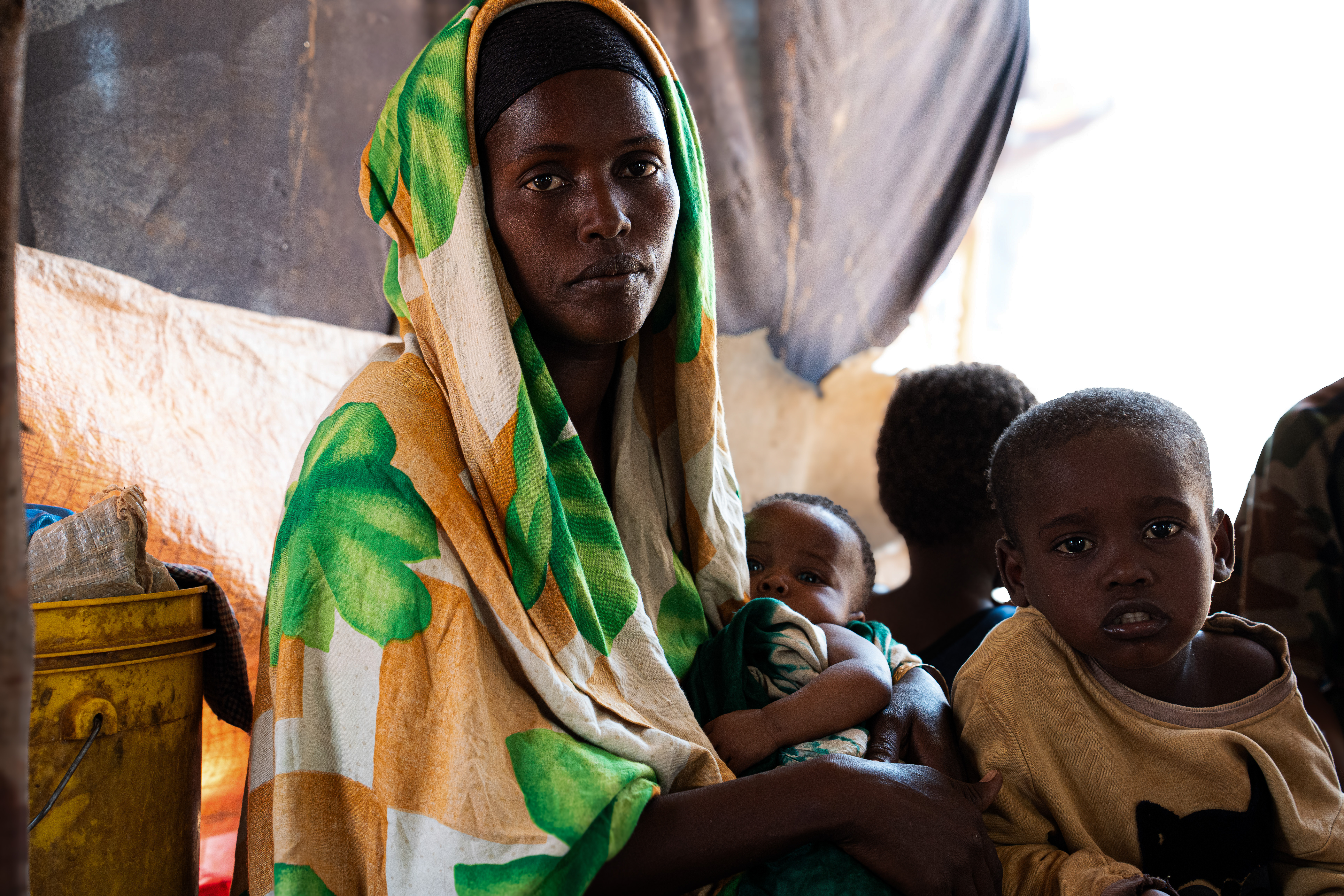 Shamsa Abdiwahab is 27 years old mother of seven, fled her home after drought destroyed the family's livelihood and sought refuge at a displacement camp in Dollow. With almost no access to food, the family survives on a single meal a day. "When my six-month-old baby cries because there is little milk," she says, "that is my most painful moment." Dollow, Gedo region, Somalia. [Abdulkadir Mohamed/NRC]