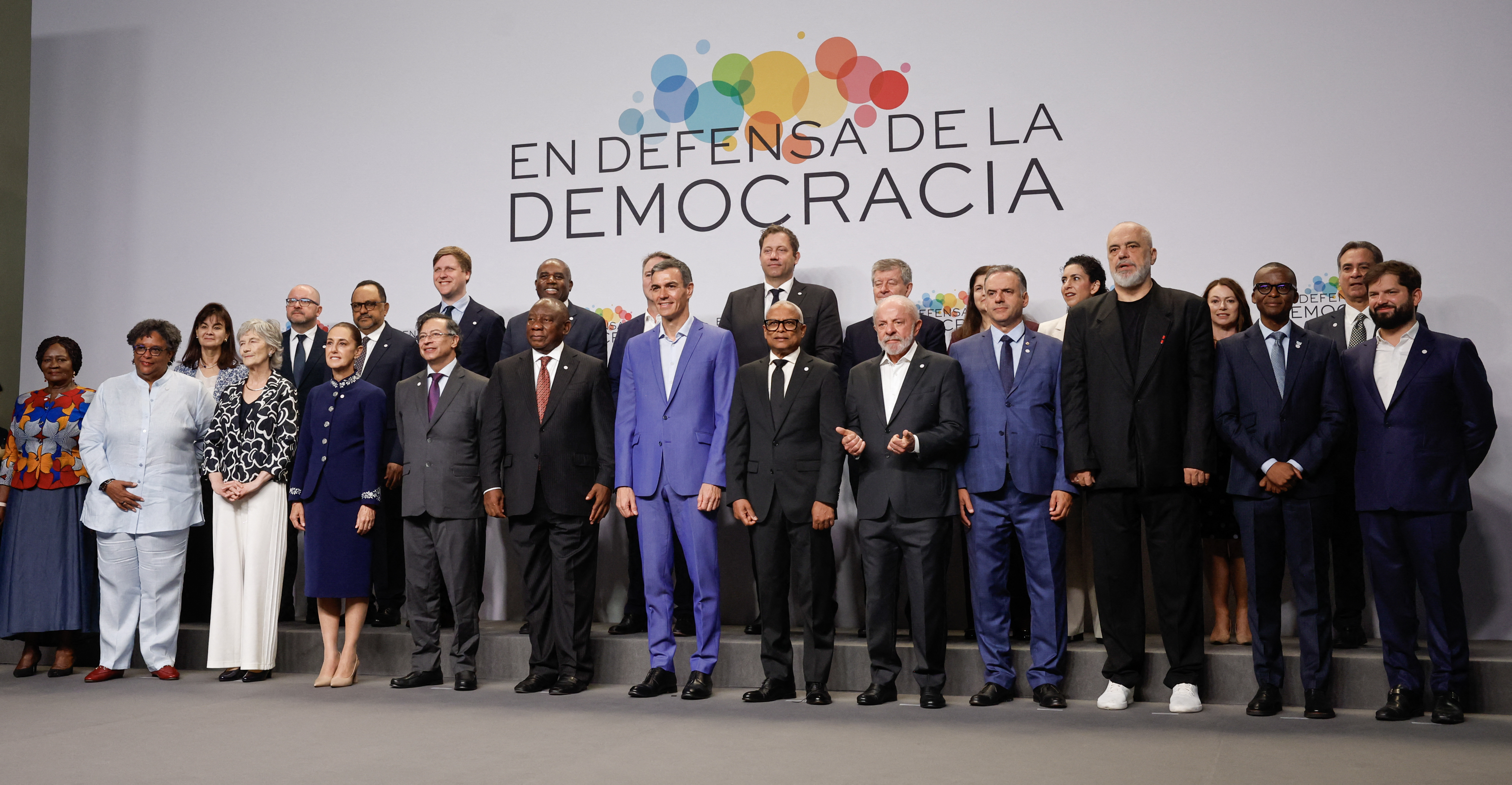 (From L front row) Ghana's Vice-President Naana Jane Opoku-Agyemang, Barbados' Prime Minister Mia Mottley, Ireland's President Catherine Connolly, Mexico's President Claudia Sheinbaum, Guest, Colombia's President Gustavo Petro, South Africa's President Cyril Ramaphosa, Spain's Prime Minister Pedro Sanchez, Cape Verde's President Jose Maria Neves, Guest, Brazilian President Luiz Inacio Lula Da Silva, Uruguay's President Yamandu Orsi, Albania's Prime Minister Edi Rama, Botswana's Vice-President Ndaba Gaolathe, and, former President of Chile Gabriel Boricpose for a family photo at a "Meeting in Defence of Democracy", a meeting of leftist leaders seeking to rally against the threat to democracy from the far right in Barcelona on April 18, 2026.