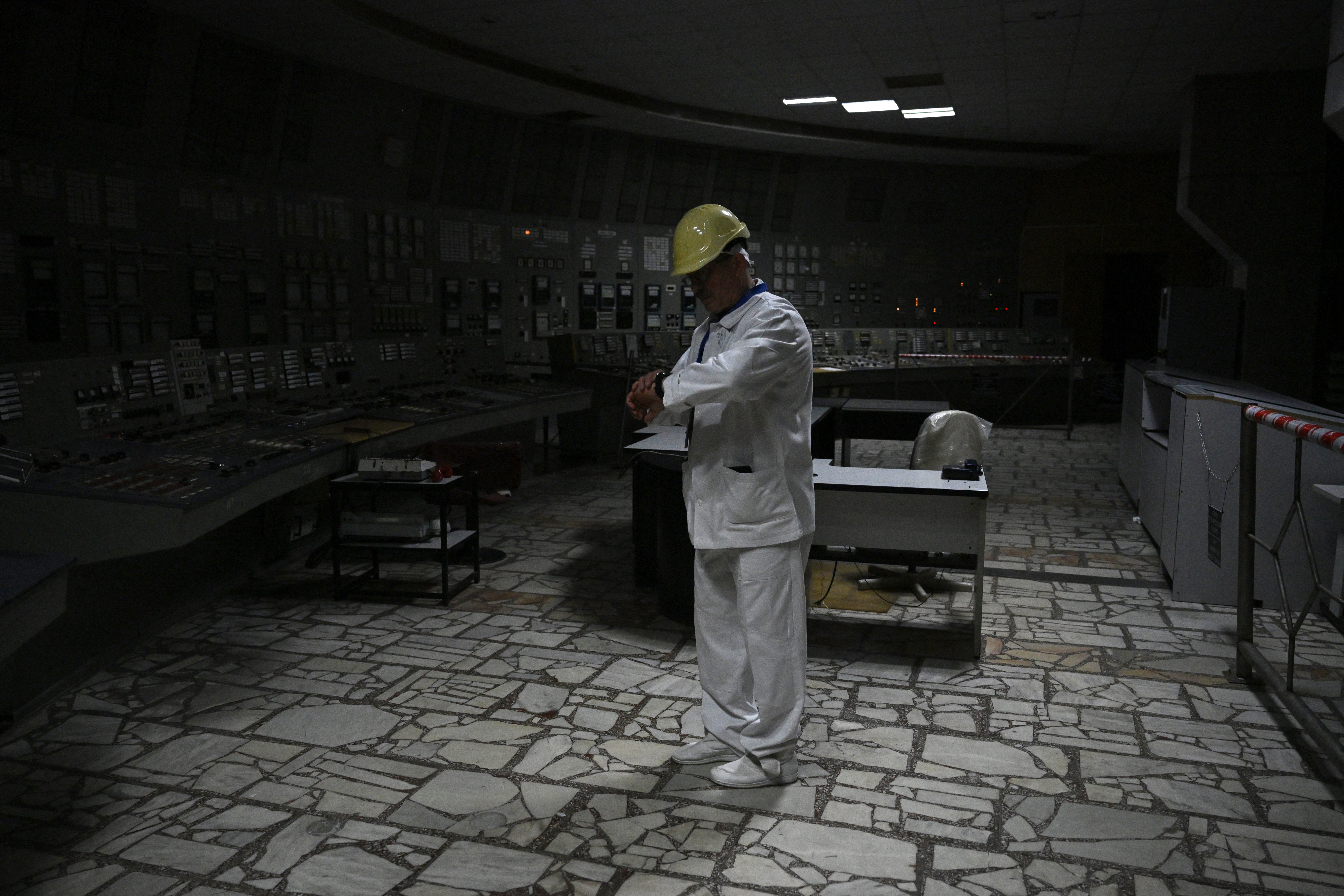 TOPSHOT - Chornobyl Nuclear Power Plant deputy technical director for radioactive waste management Oleksandr Skomarokhov, stands in the control room of the no longer working reactor 3 of the Chornobyl Nuclear Power Plant on April 9, 2026, amid the Russian invasion of Ukraine.
