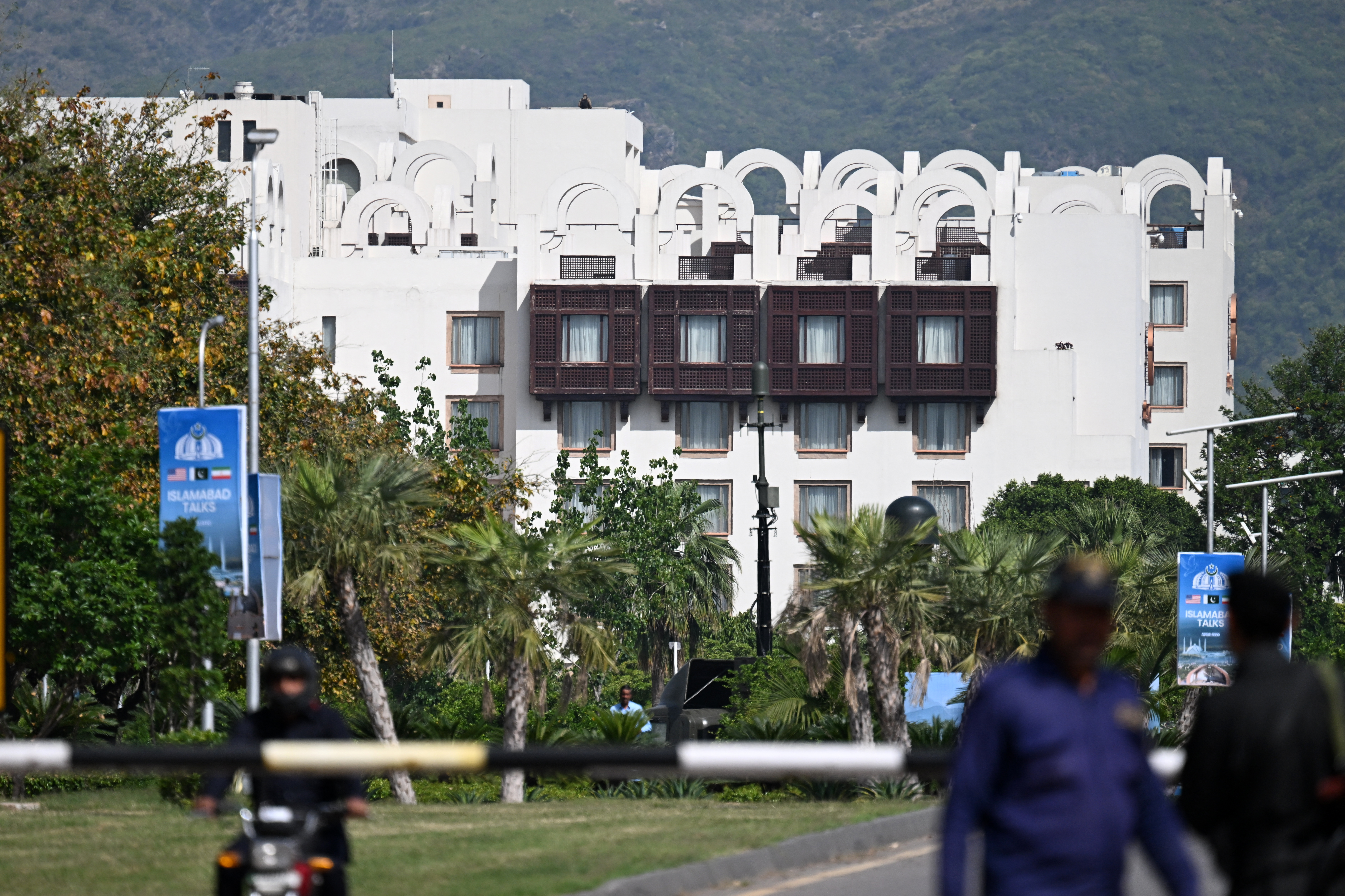 Police personnel stand guard near the Serena Hotel in the Red Zone area of Islamabad