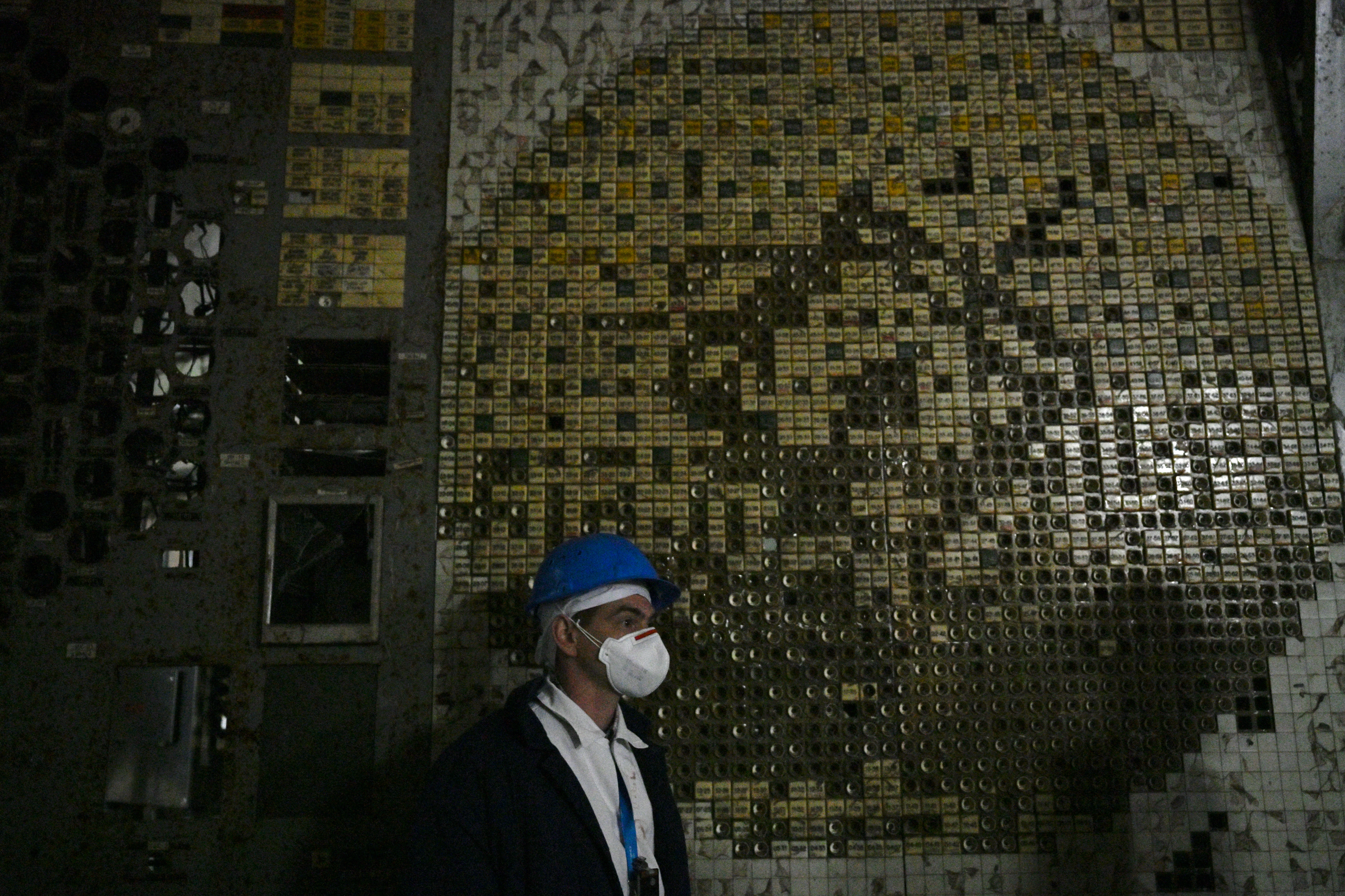 An employee of the Chornobyl Nuclear Power Plant stands in the control room of the destroyed 4th block of the plant on April 9, 2026, amid the Russian invasion of Ukraine.