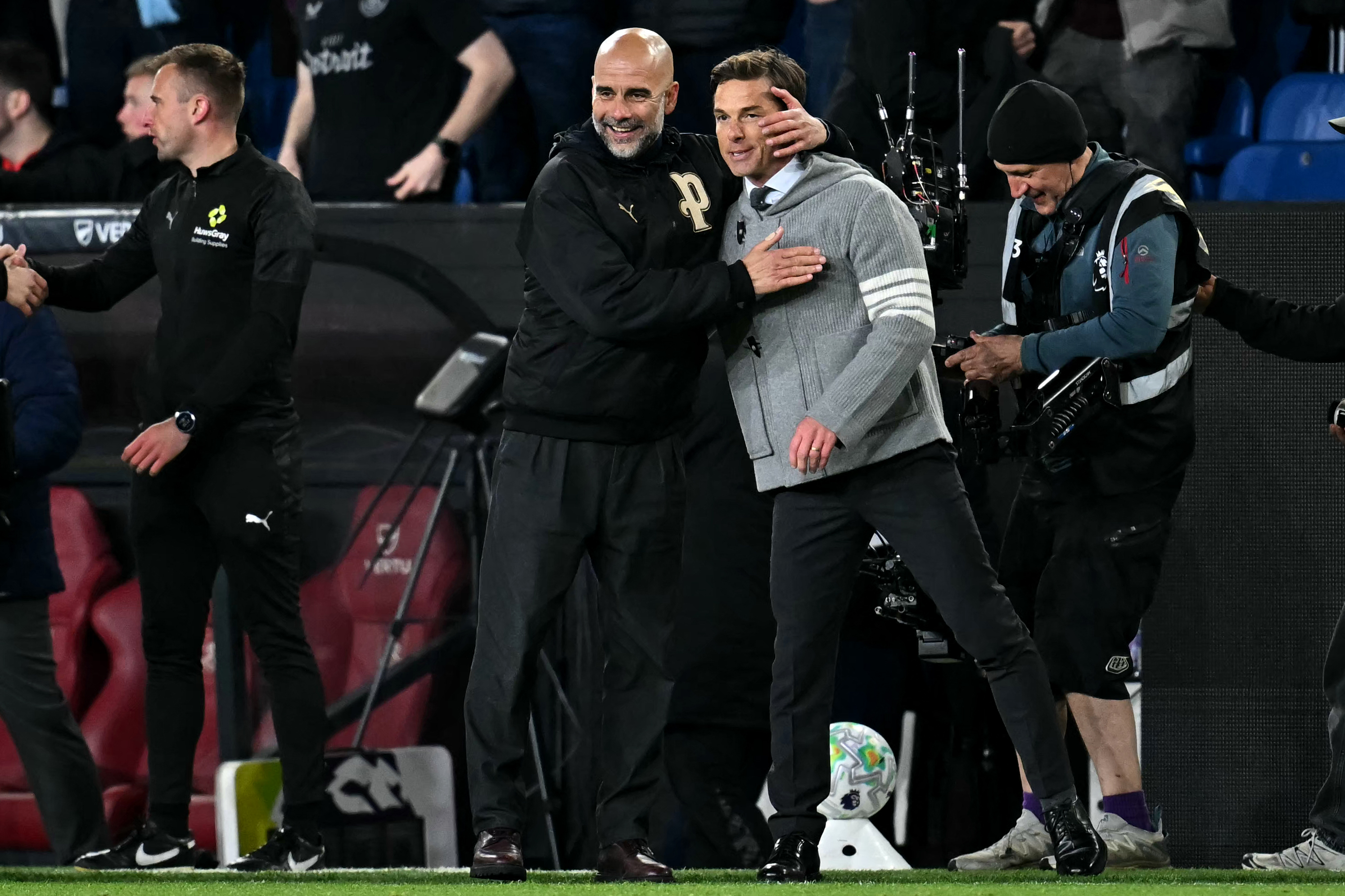 Manchester City's Spanish manager Pep Guardiola reacts with Burnley's English manager Scott Parker after the English Premier League football match between Burnley and Manchester City at Turf Moor in Burnley, north-west England on April 22, 2026. (Photo by Paul ELLIS / AFP) / RESTRICTED TO EDITORIAL USE. NO USE WITH UNAUTHORIZED AUDIO, VIDEO, DATA, FIXTURE LISTS, CLUB/LEAGUE LOGOS OR 'LIVE' SERVICES. ONLINE IN-MATCH USE LIMITED TO 120 IMAGES. AN ADDITIONAL 40 IMAGES MAY BE USED IN EXTRA TIME. NO VIDEO EMULATION. SOCIAL MEDIA IN-MATCH USE LIMITED TO 120 IMAGES. AN ADDITIONAL 40 IMAGES MAY BE USED IN EXTRA TIME. NO USE IN BETTING PUBLICATIONS, GAMES OR SINGLE CLUB/LEAGUE/PLAYER PUBLICATIONS.