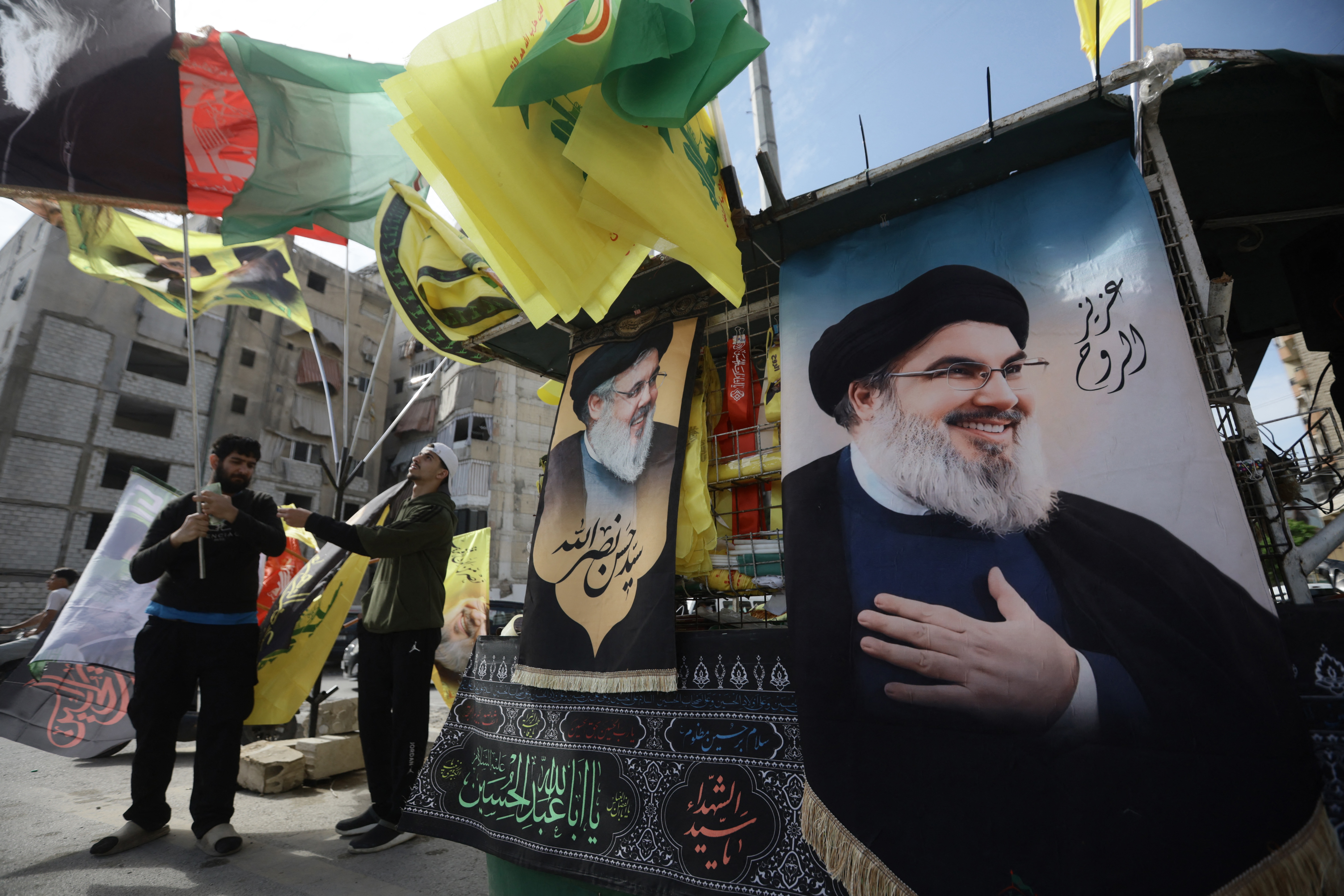 TOPSHOT - An image of slain Hezbollah leader Hassan Nasrallah, who was killed by Israel in 2024, is seen as Hezbollah supporters gather for a solidarity rally against the United States and Israel, in Beirut’s southern suburbs on April 25, 2026.