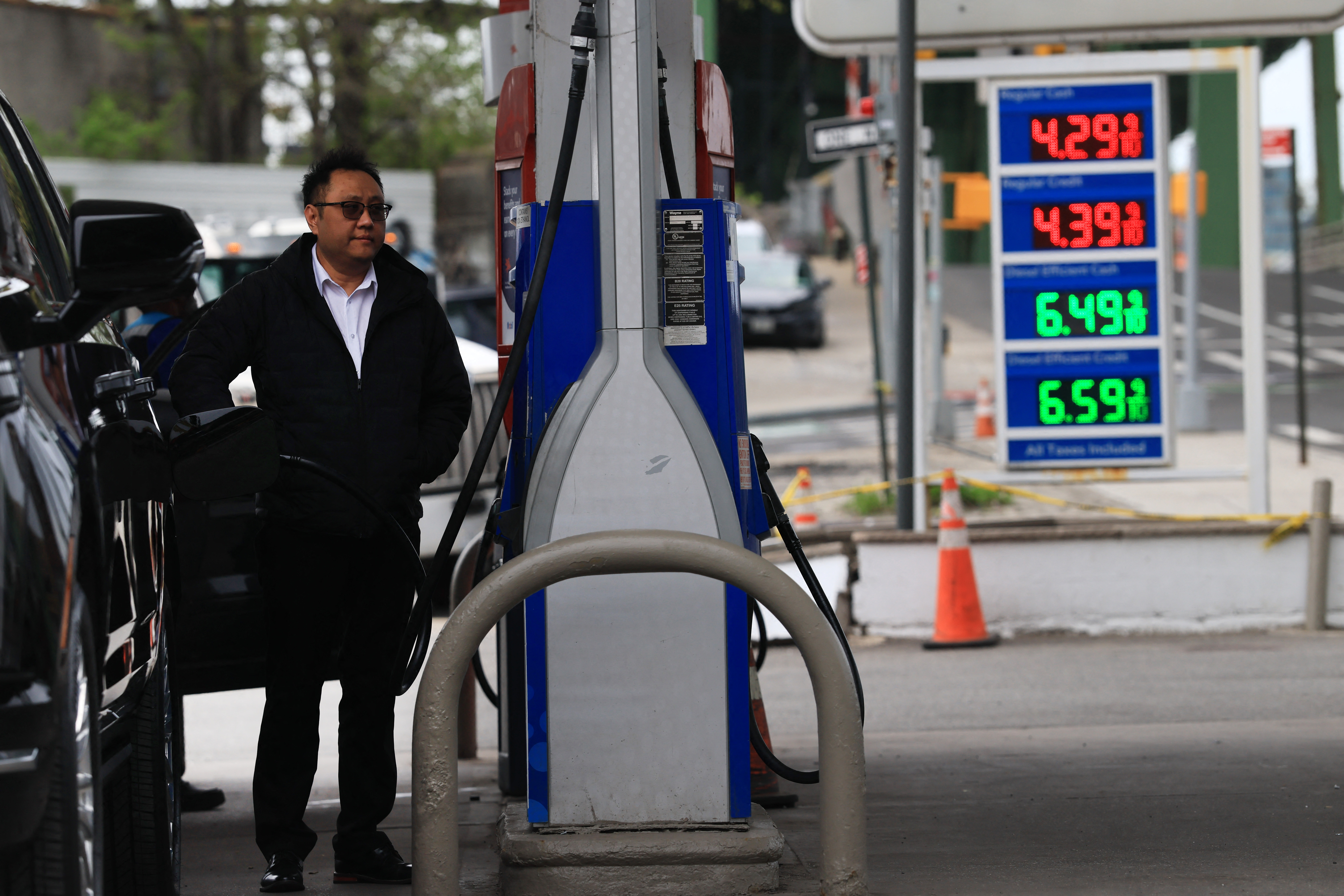 Fuel prices are displayed at a gas station.