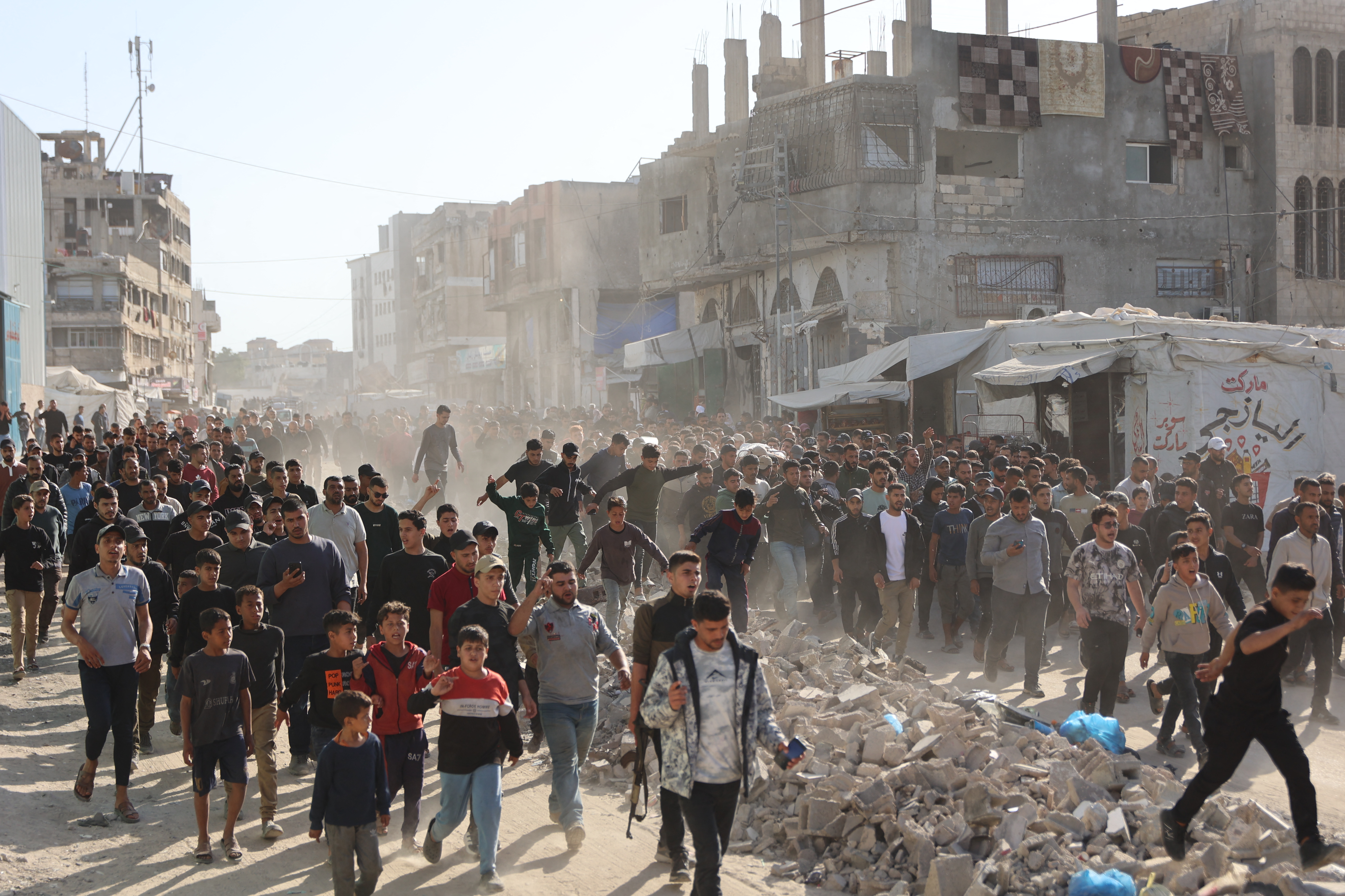 Displaced Palestinians attend the funeral after four people were killed by an Israeli strike