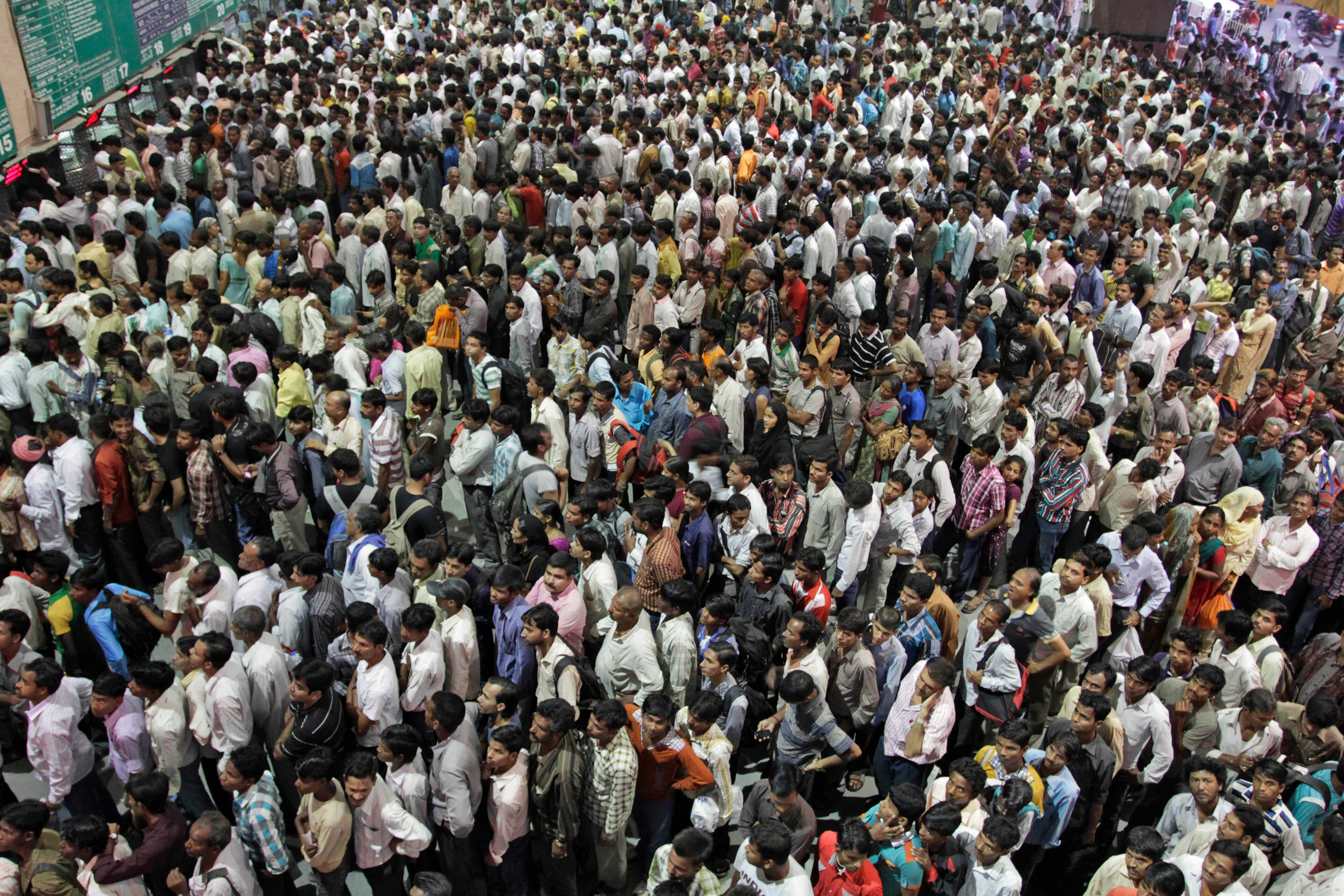 FILE - Indians crowd ticket counters at a railway station in Ahmadabad, India, Oct. 23, 2011. (AP Photo/Ajit Solanki, File)