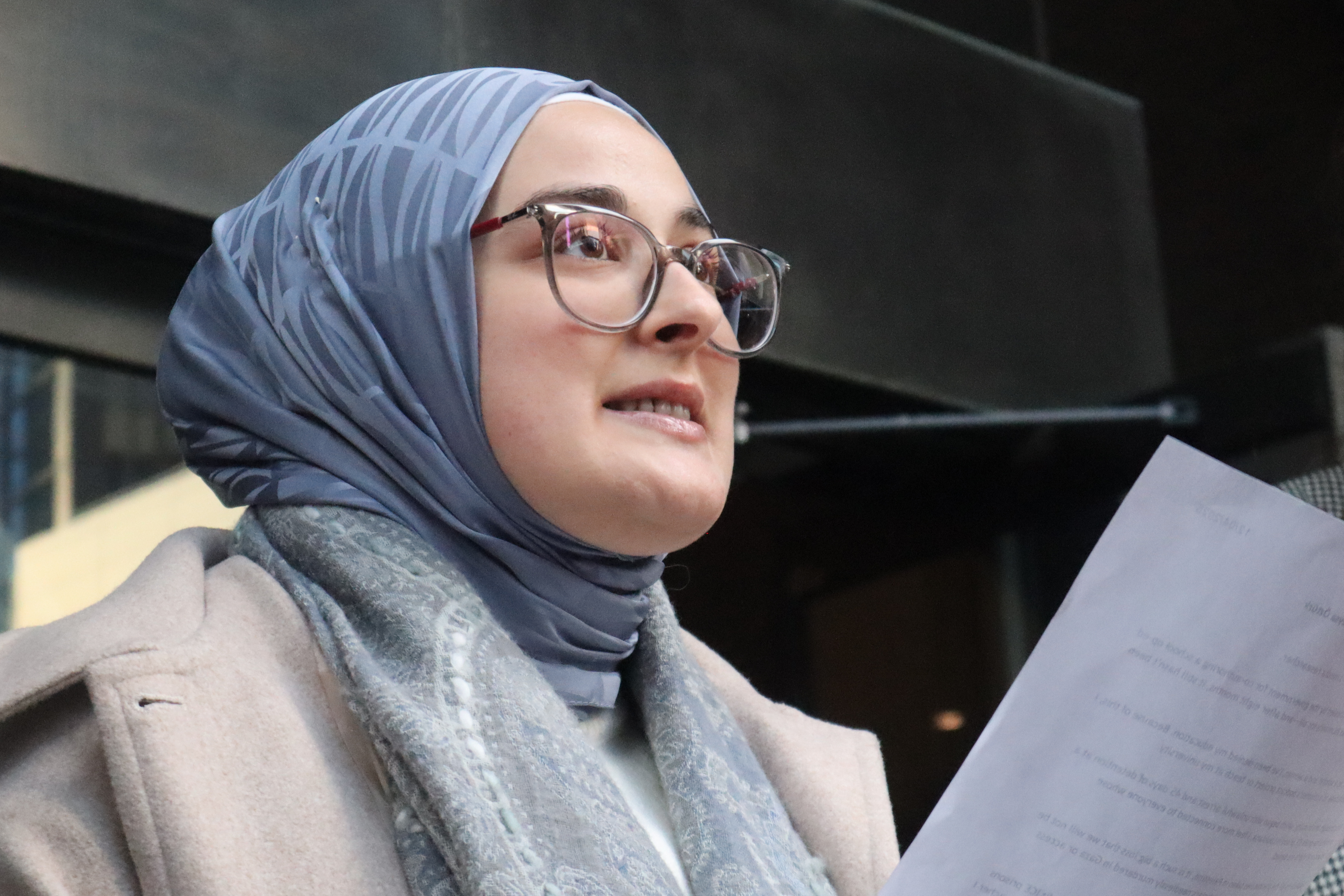 Tufts University doctoral student Rumeysa Ozturk reads from a prepared statement.