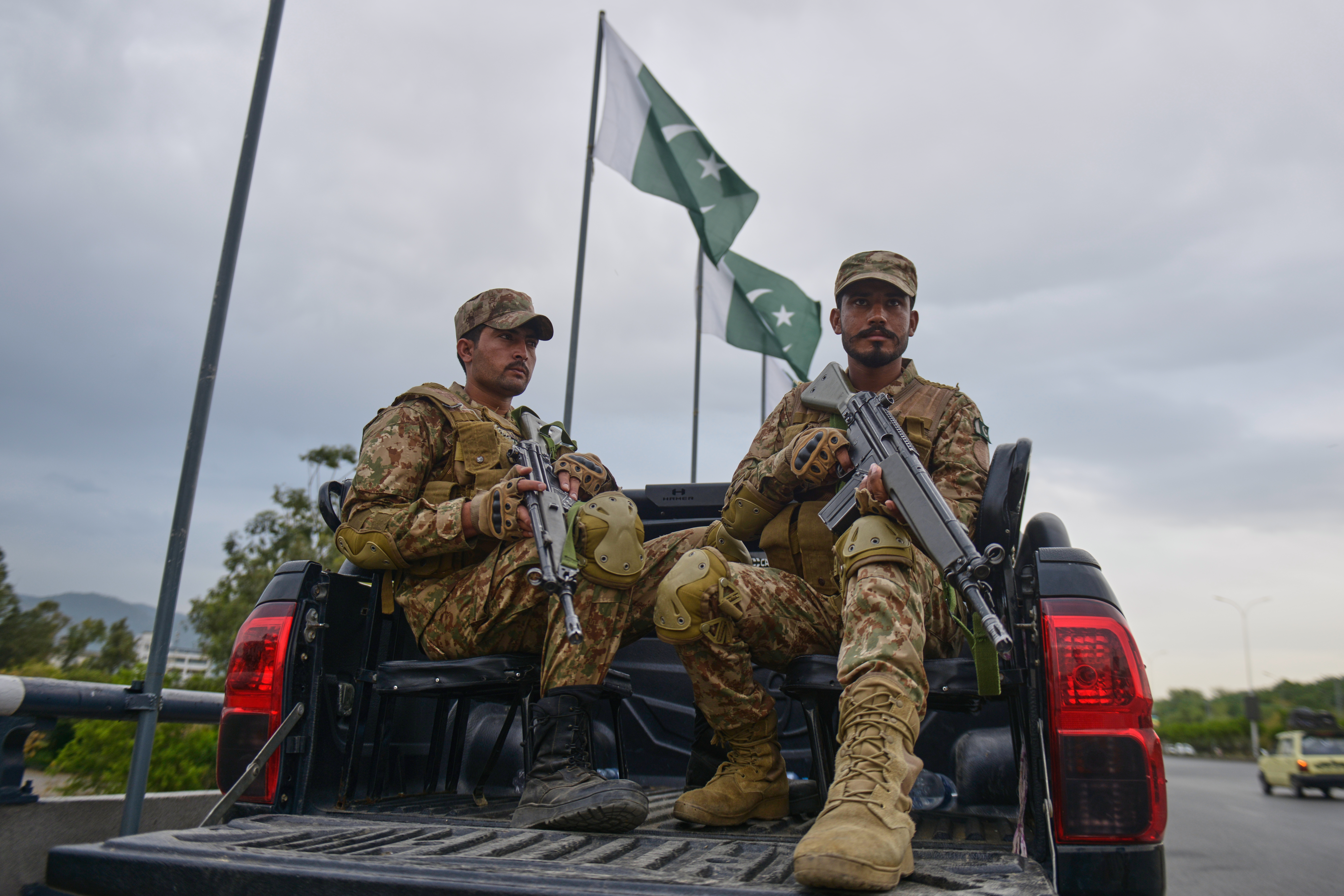 Army soldiers take positions in an overhead bridge to ensure security in Islamabad, Pakistan, Friday, April 24, 2026. (AP Photo/M.A. Sheikh)