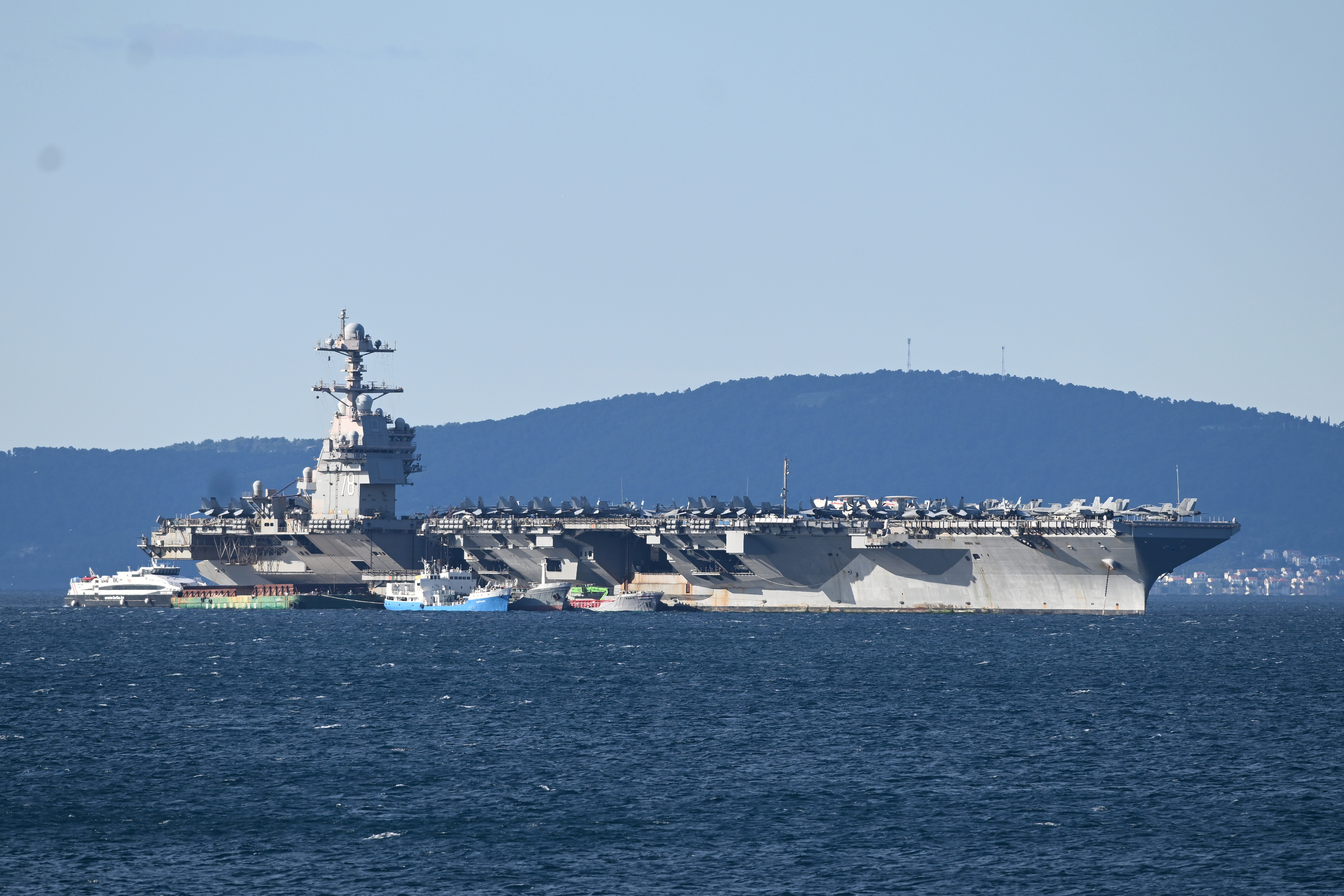 epaselect epa12858424 The US Navy aircraft carrier USS Gerald R. Ford (CVN-78) sits anchored in Split, Croatia, 29 March 2026. The ship arrived for repairs following a non-combat fire during operations in the Red Sea. The world's largest carrier, which recently supported Operation Epic Fury, transitioned to the NATO-allied port after a March 12 laundry room fire injured three sailors and damaged sleeping quarters. The vessel remains a centerpiece of US naval power, housing over 5,000 crew members and 75 military aircraft. EPA/STRINGER
