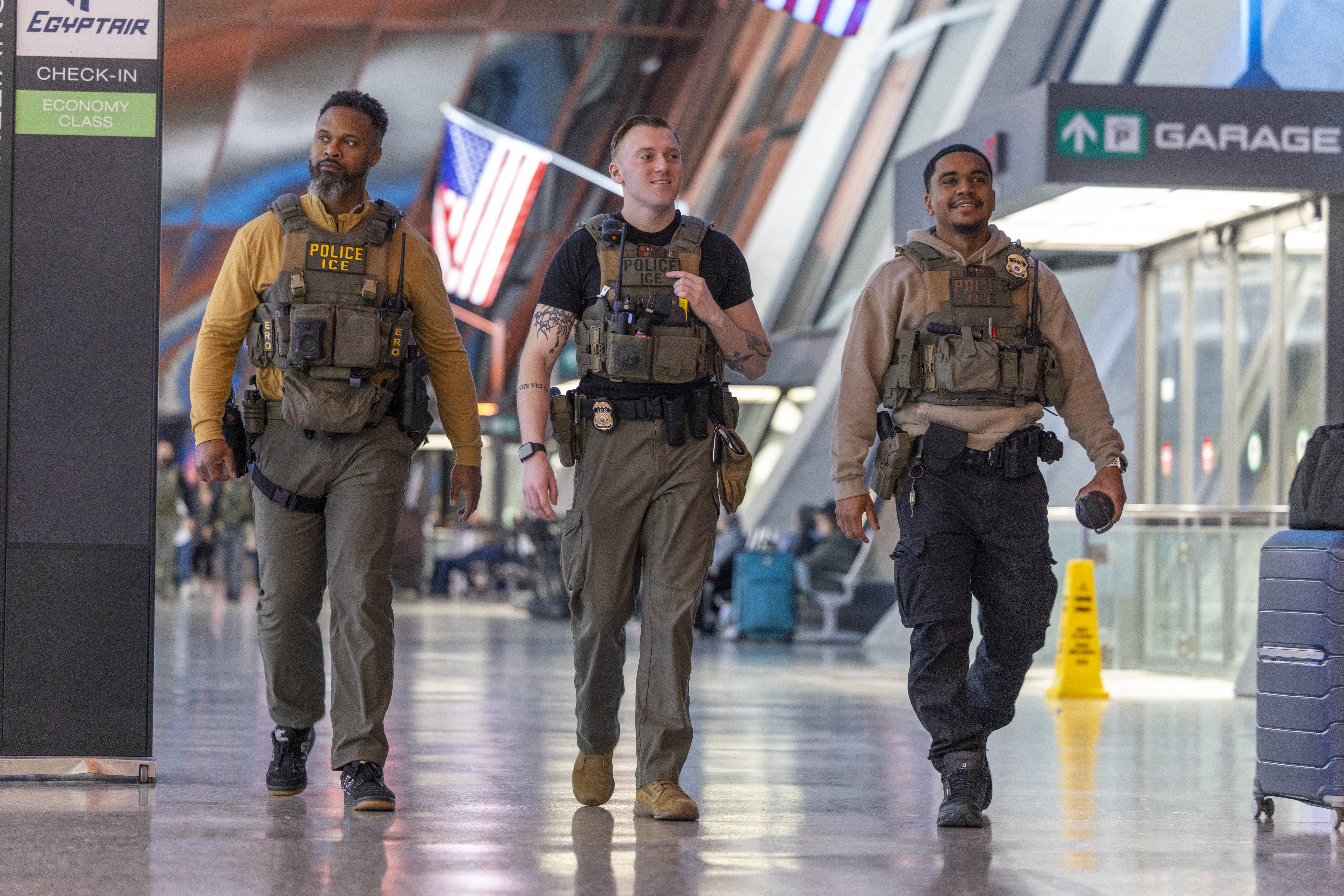 epa12850819 Immigration and Customs Enforcement (ICE) officers patrol Dulles International Airport in Dulles, Virginia, USA, 26 March 2026. ICE agents have begun checking passengers' IDs at some airports, working alongside TSA officers, roughly 50,000 of whom are working unpaid due to a partial Department of Homeland Security shutdown, to help reduce extended wait times. EPA/SHAWN THEW