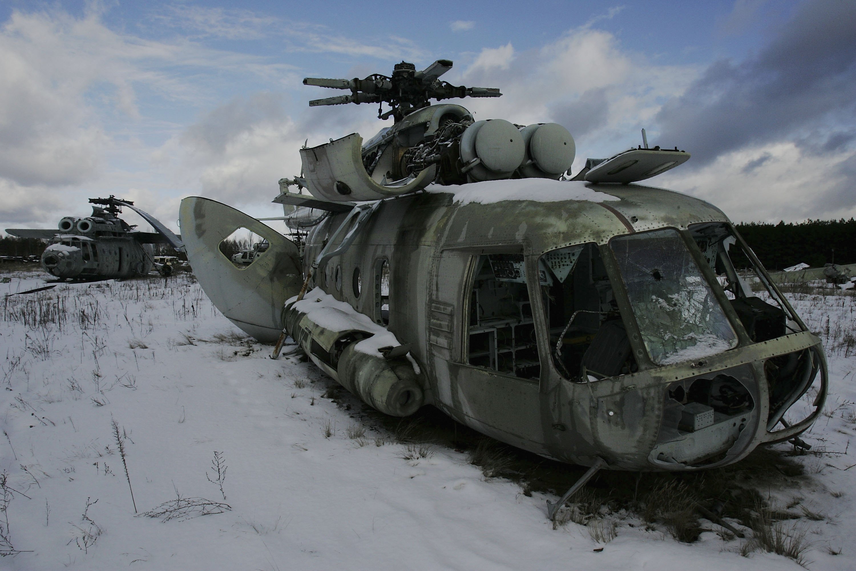 CHERNOBYL - JANUARY 31: Highly radiated helicopters used to dump concrete and water on the reactor 4 during the 1986 catastrophe lay in a field near the village of Rosoha on January 31, 2006 in Chernobyl, Ukraine. From April 27 to May 5, more than 30 military helicopters flew over the burning reactor. They failed to put out the fire with 2400 tonnes of lead and 1800 tonnes of sand. Tanks, helicopters, and all terrain vehicles from the Soviet Union's Red Army were left in this dump due to their high levels of radiation. (Photo by Daniel Berehulak/Getty Images)