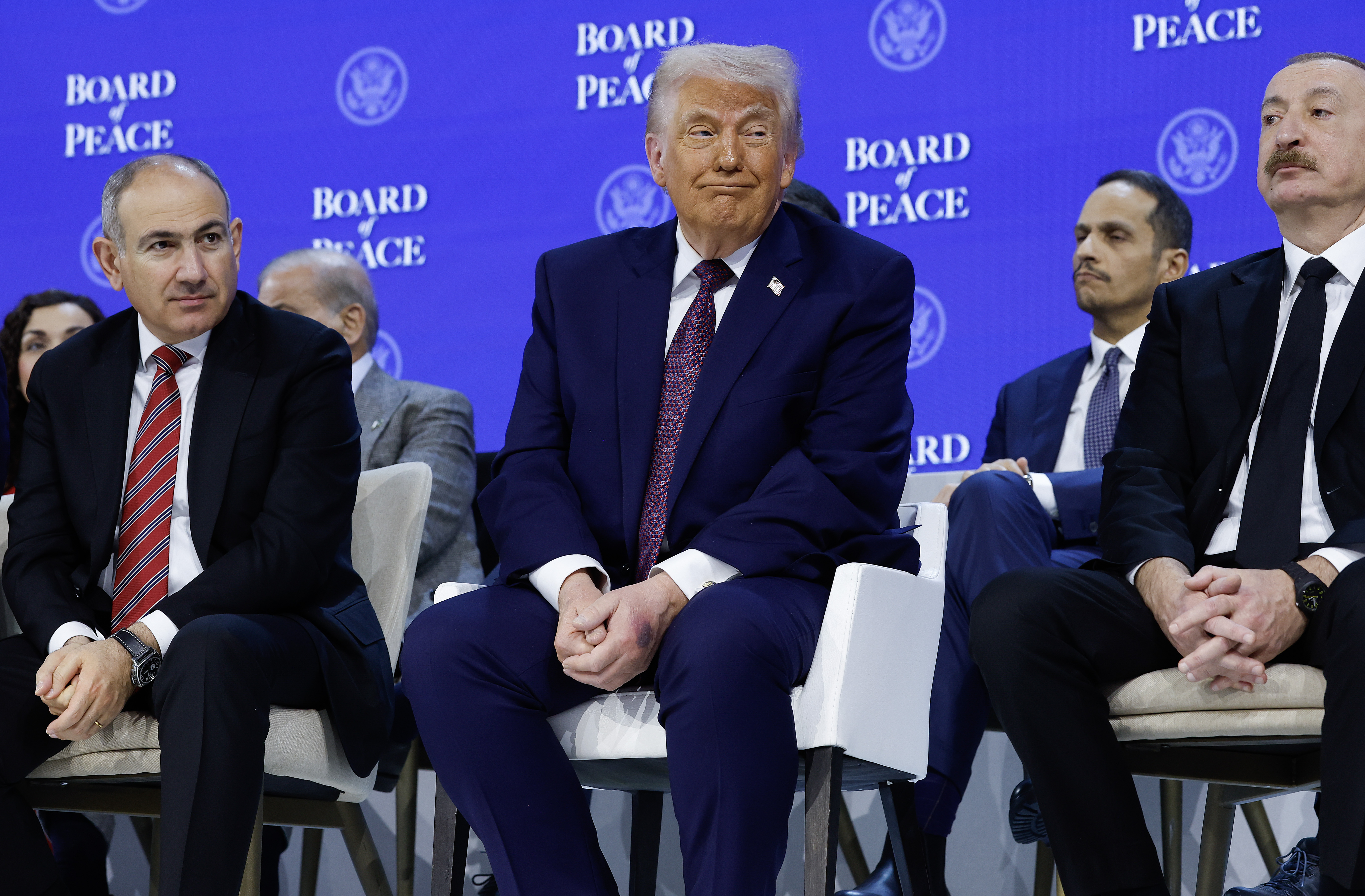 US President Donald Trump (C) sits between Prime Minister of Armenia Nikol Pashinyan (L) and Azerbaijan President Ilham Aliyev during a signing ceremony.