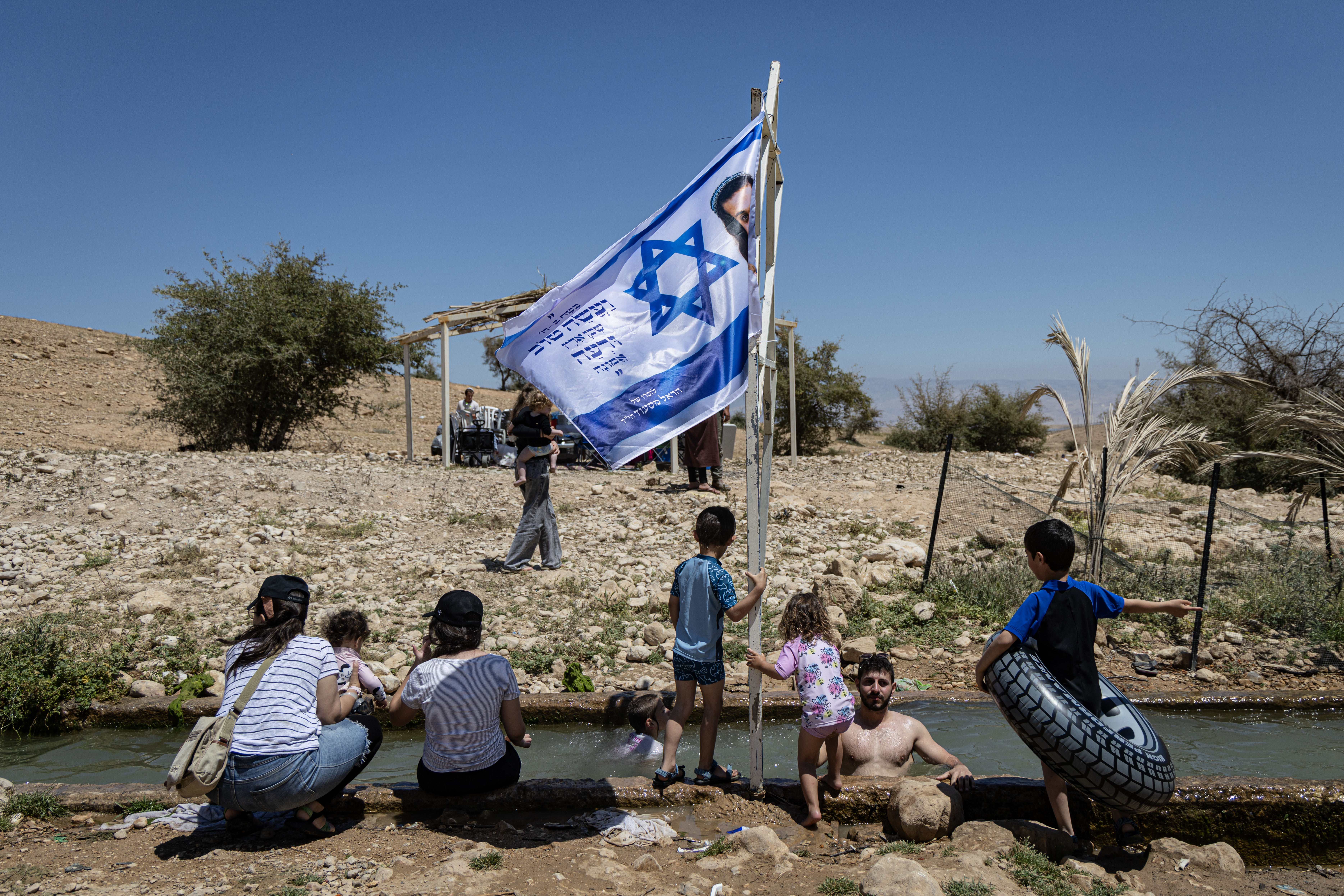 RAS EIN AL-AUJA, WEST BANK -APRIL 22: Israeli settlers gather at a water spring in the Israeli-occupied West Bank village of Ras Ein al-Auja on April 22, 2026, in the Israeli-occupied West Bank village of Ras Ein al-Auja. Israelis celebrate Independence Day at the Palestinian spring of Ein al-Auja, marking 78 years of Israel's independence. The local Bedouin community was displaced by Israeli settlers earlier this year. (Photo by Faiz Abu Rmeleh/Getty Images)