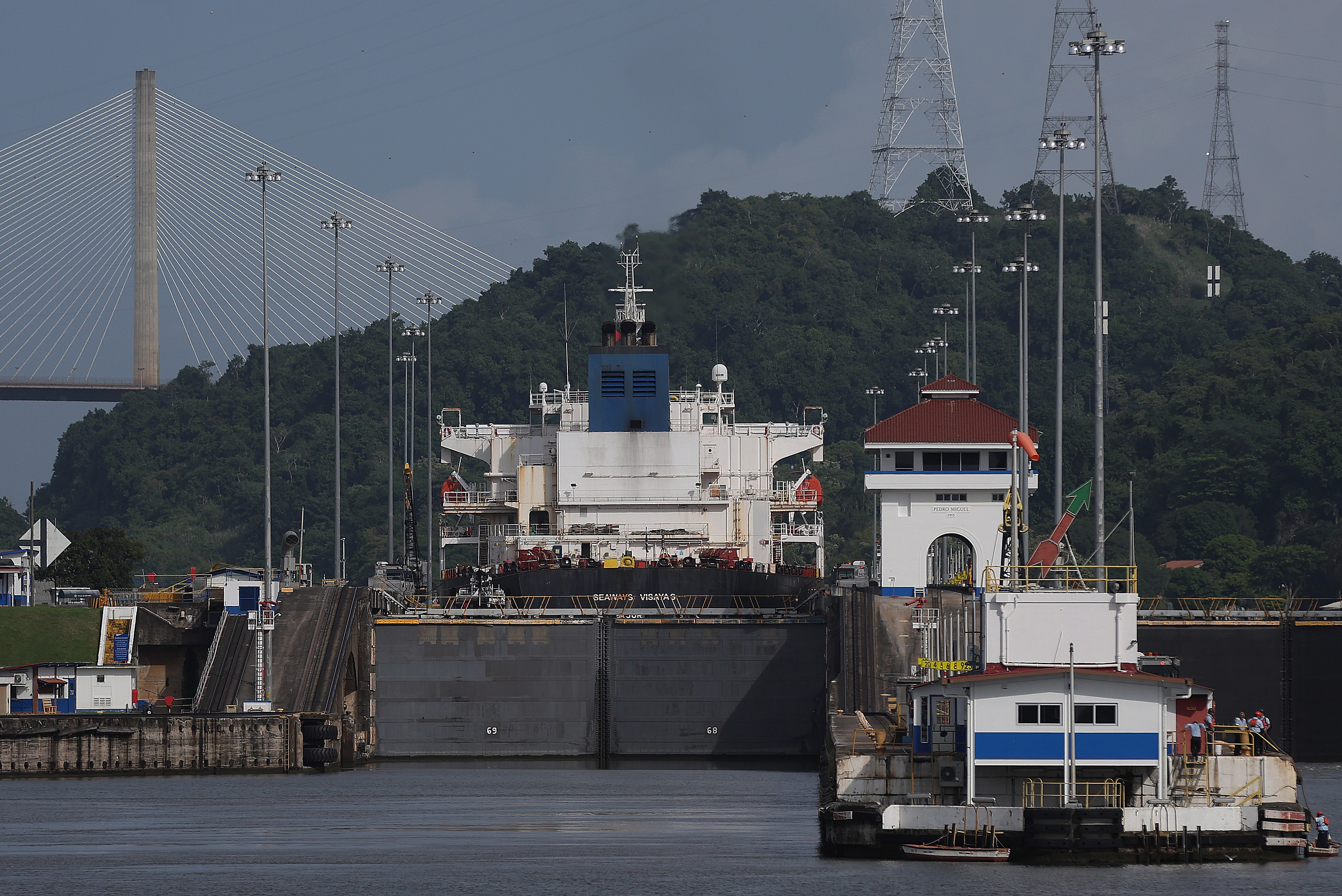 PEDRO MIGUEL, PANAMA - SEPTEMBER 23: Crude oil tanker Seaways Visayas passes through the Pedro Miguel locks while transiting the Panama Canal on September 23, 2023 in Pedro Miguel, Panama. The Panama Canal Authority is continuing to restrict the number of vessels that pass through the Panama Canal locks as drought has caused water levels at Gatun Lake to drop. The locks depend on millions of gallons of fresh water from the manmade lake to fill locks in Panama City and Colon in order to transit shipping vessels from the Pacific Ocean to the Caribbean Sea. Over 100 ships are waiting to transit the canal and the backup could delay goods heading to the United States for the holiday season. It takes an average of 8-10 hours for a ship to transit the 50 miles through the canal versus several weeks to travel thousands of miles around Cape Horn and the southernmost parts of South America. (Photo by Justin Sullivan/Getty Images)