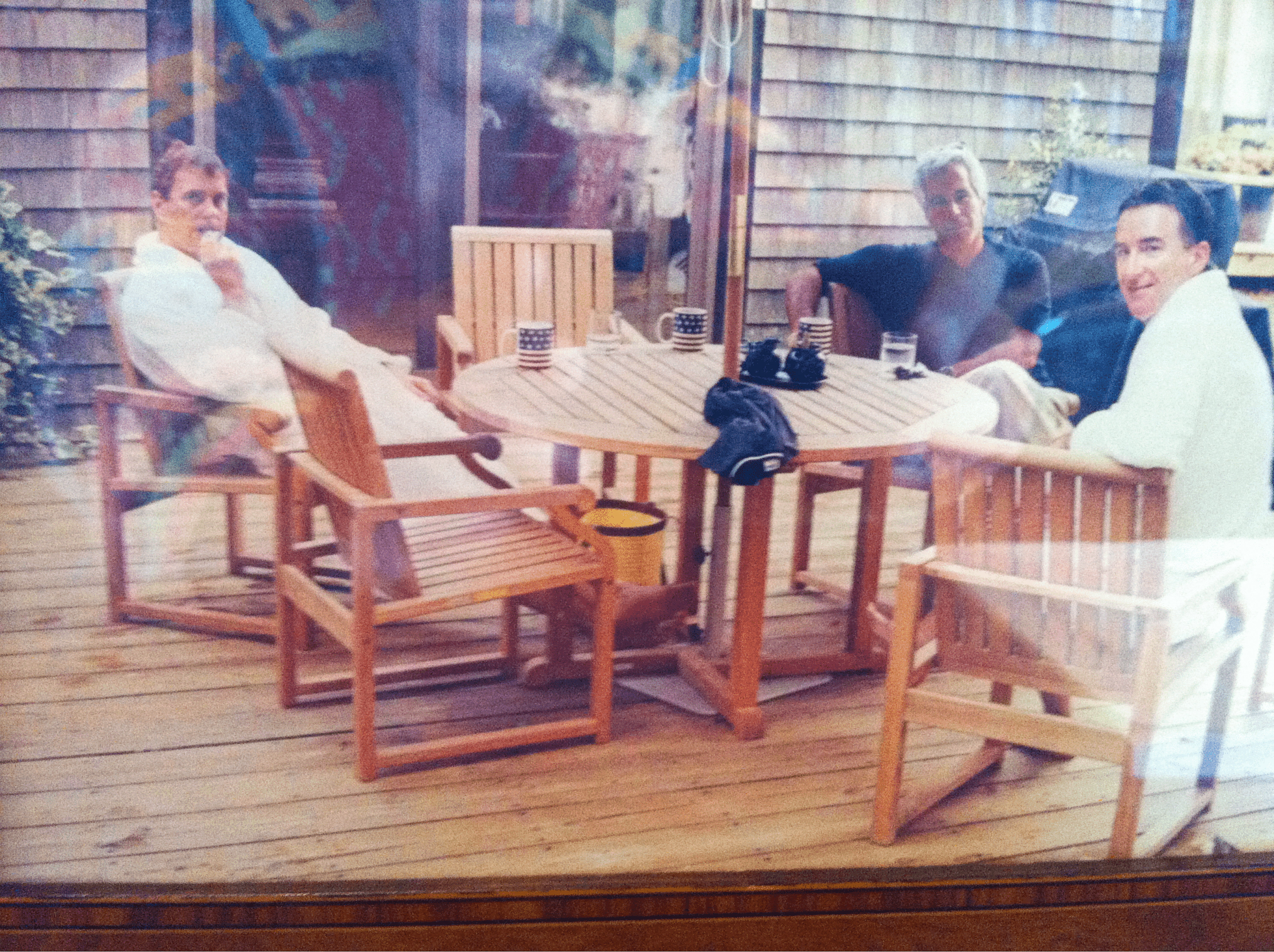 Andrew Mountbatten-Windsor and Lord Peter Mandelson are seen wearing bathrobes seated alongside late financier and convicted sex offender Jeffrey Epstein, in an undated photograph released by the Department of Justice in Washington, D.C., U.S., as part of a trove of documents from its investigations into Epstein. U.S. Justice Department/Handout via REUTERS THIS IMAGE HAS BEEN SUPPLIED BY A THIRD PARTY.