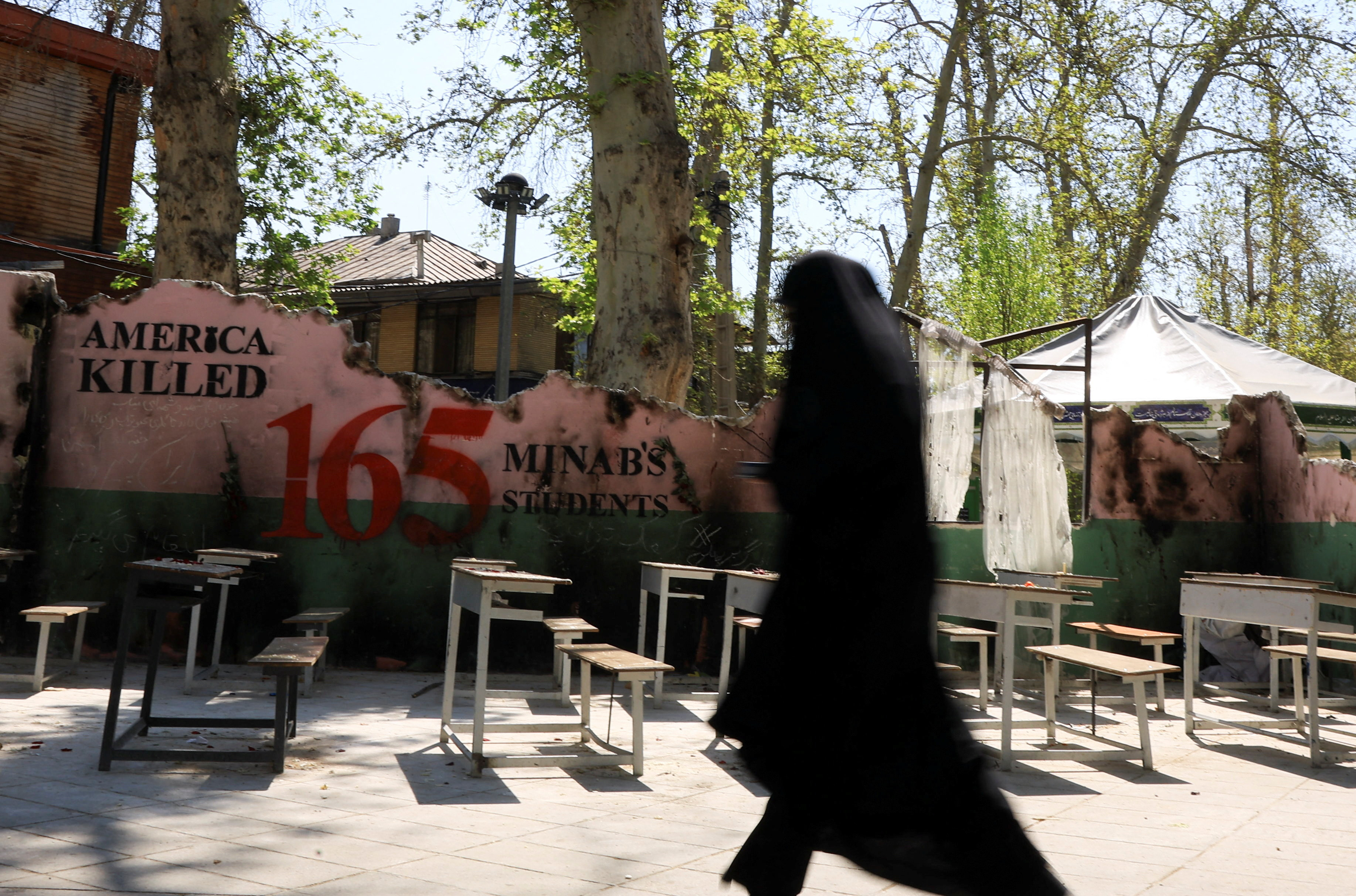 An Iranian woman walks past a monument for schoolchildren who were killed in a strike on a girls' primary school in Minab, southern Iran, amid a ceasefire between the U.S. and Iran, in Tehran, Iran, April 15, 2026. REUTERS/Thaier Al Sudani Foreign media in Iran operate under guidelines set by the Ministry of Culture and Islamic Guidance, which regulates press activity and permissions.