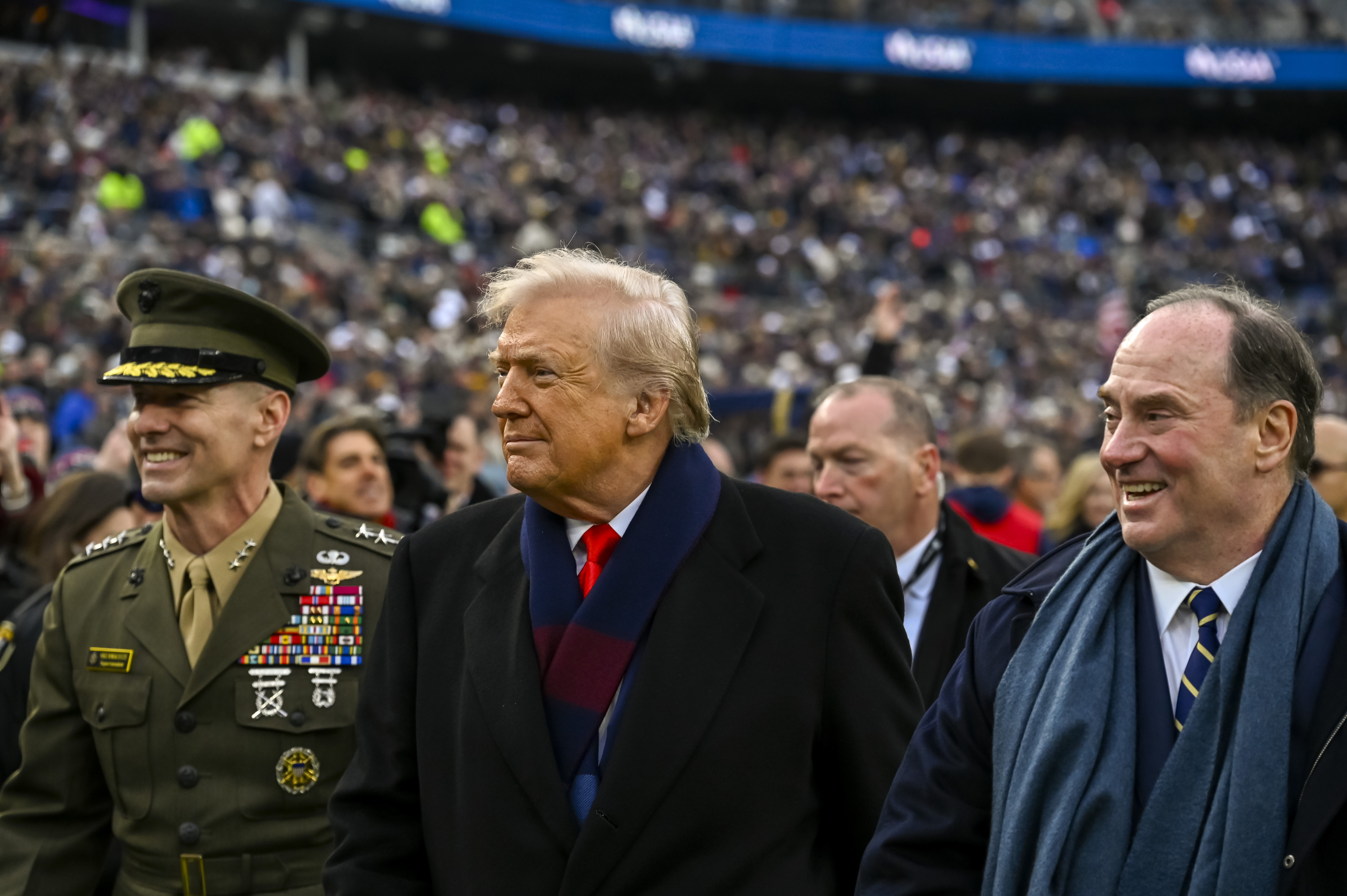 Dec 13, 2025; Baltimore, Maryland, USA; President Donald J Trump walks with U.S. Marine Corps Lieutenant General Michael Borgschulte and Secretary of the Navy John Phelan before the game between the Navy Midshipmen and the Army West Point Black Knights at M&T Bank Stadium. Mandatory Credit: Tommy Gilligan-Imagn Images