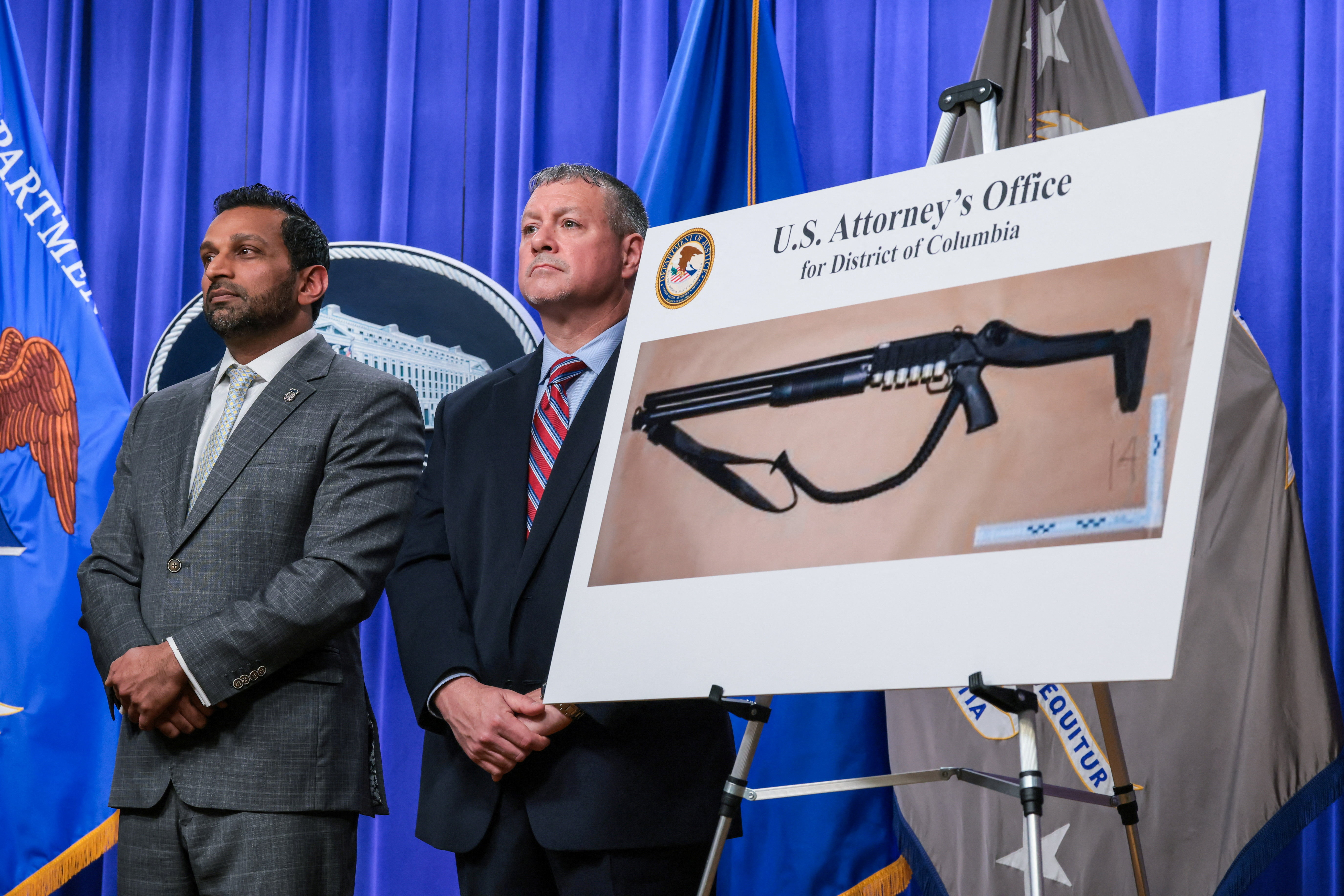 U.S. Federal Bureau of Investigation (FBI) Director Kash Patel and Assistant Director in Charge (ADIC) of the FBI Washington Field Office Darren Cox stand next to a picture of a shotgun carried by Cole Tomas Allen, the suspect in the shooting incident in Washington at the annual White House Correspondents' Association dinner, during a press conference at the U.S. Department of Justice about the shooting incident, in Washington, D.C., U.S., April 27, 2026. REUTERS/Kylie Cooper
