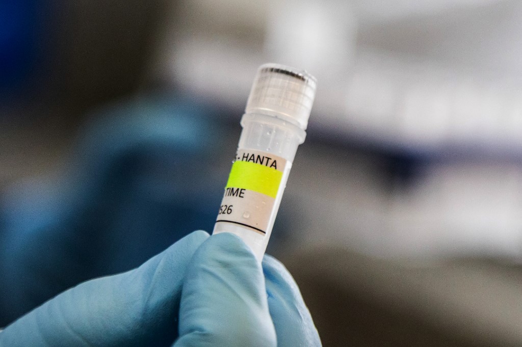 A scientist holds a test tube.