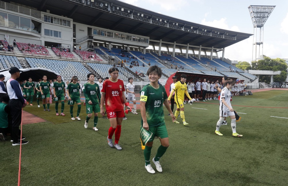 Suwon FC Women team and Tokyo Verdy Beleza team enter the pitch ahead of the AFC Women's Champions League match between Suwon FC Women and Tokyo Verdy Beleza in Yangon, Myanmar