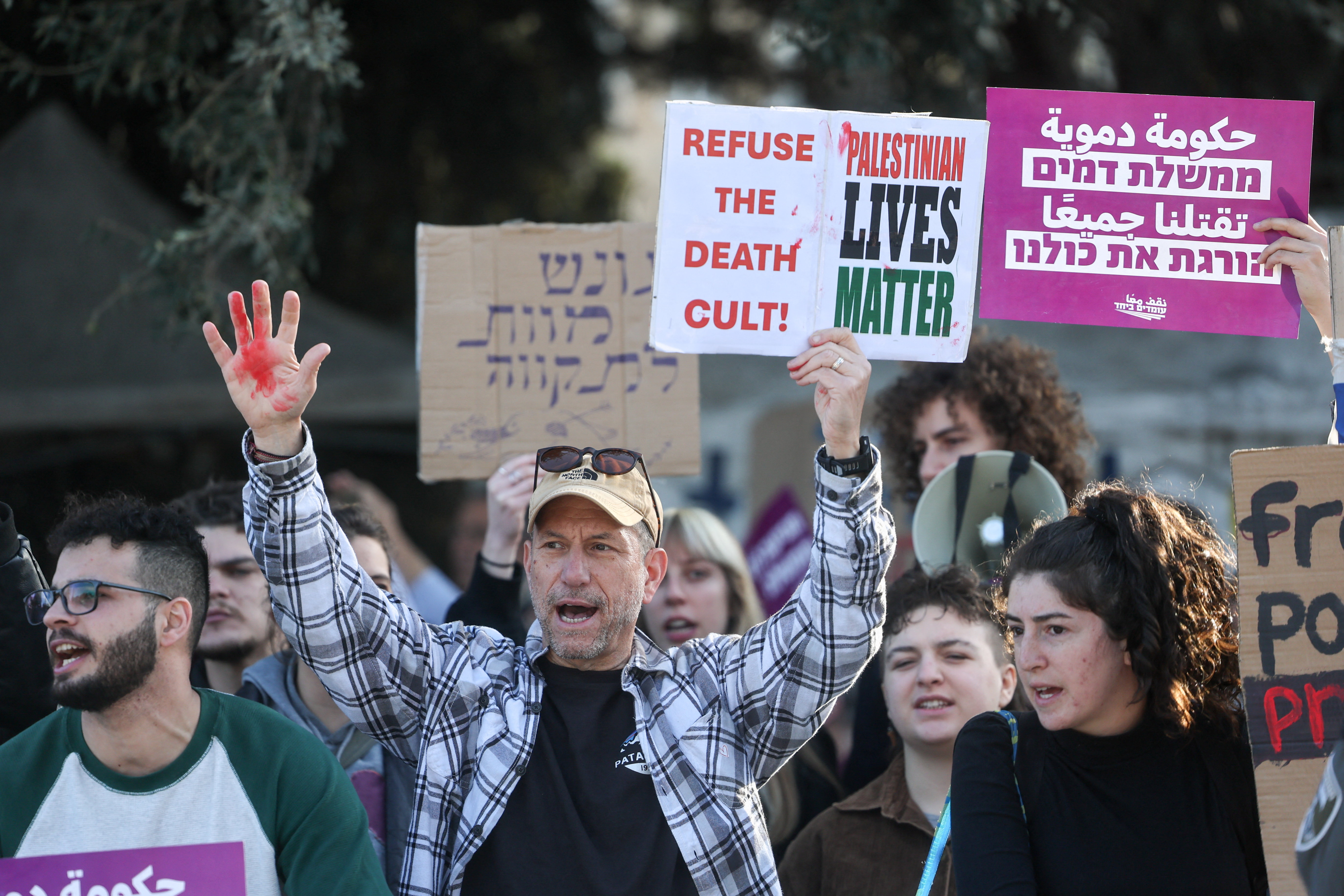 A demonstrator raises his hand covered in red paint as Israelis protest after Israel's parliament passed a law on Monday making death by hanging a default sentence for Palestinians convicted in military courts of deadly attacks, near the Knesset, Israel's parliament, in Jerusalem, March 31, 2026.