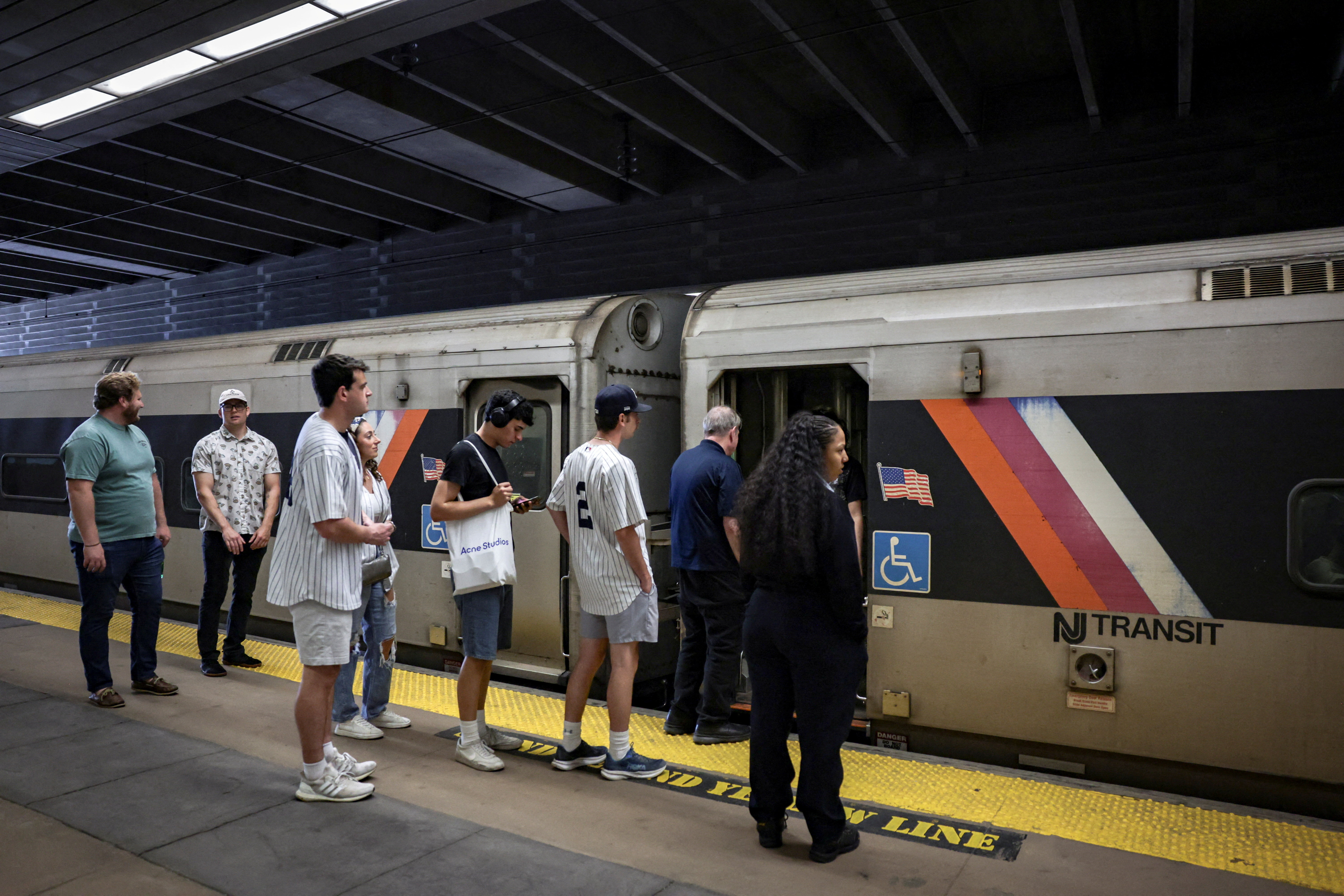 People wait to board a NJ Transit train at the Secaucus Junction station on the day of the announcement of public transit ticket prizes to World Cup games in New Jersey, in Secaucus, New Jersey, U.S., April 17, 2026. REUTERS/Jeenah Moon