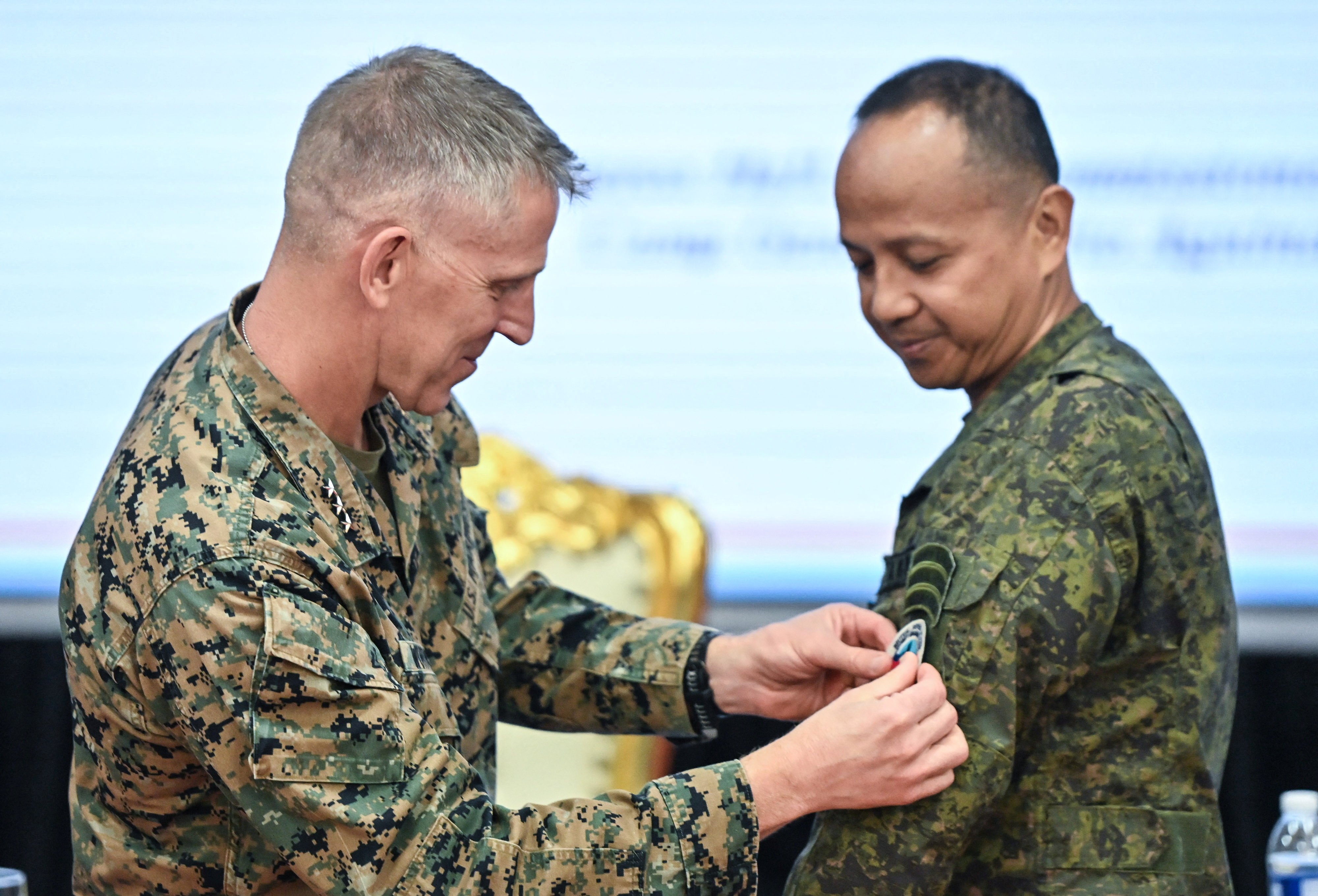 I Marine Expeditionary Force (I MEF) Commanding General and U.S. Marine Corps Lieutenant General Christian Wortman attaches the Balikatan patch to Philippine Exercise Director Francisco Lorenzo, during the opening ceremony of the U.S.-Philippines "Balikatan" joint military exercises at Camp Aguinaldo in Quezon City, Metro Manila, Philippines, April 20, 2026. REUTERS/Noel Celis